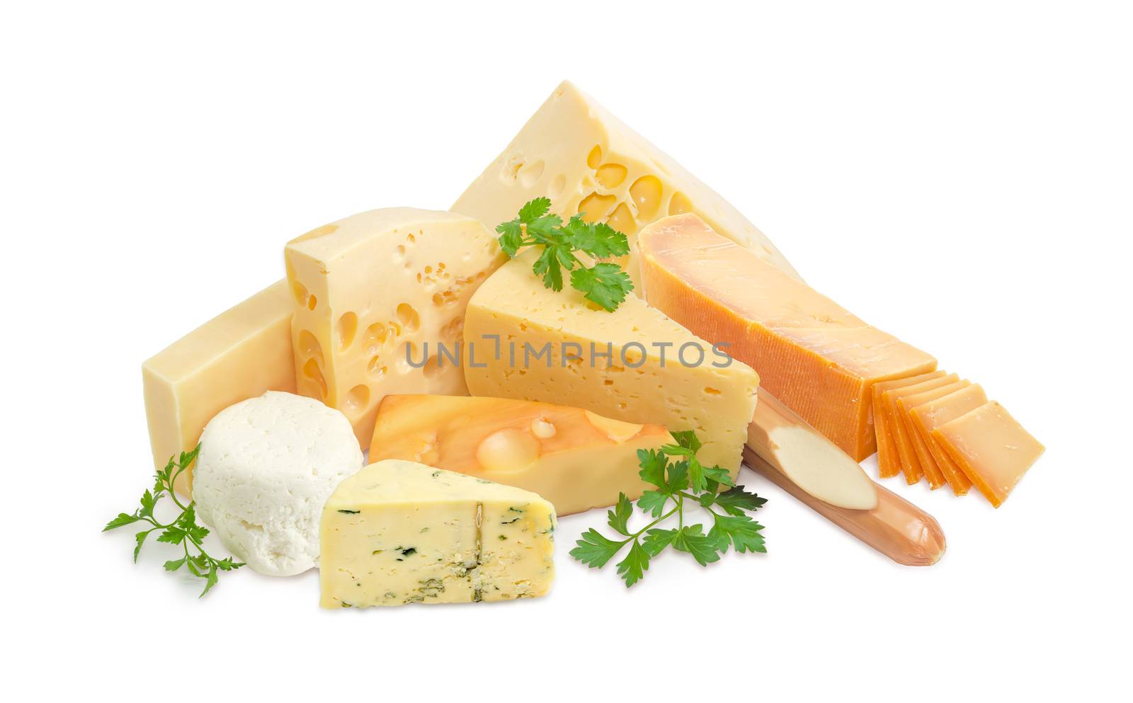 Several different pieces of hard cheese, semi-hard cheese and soft cheese various types and twigs of parsley on a light background
