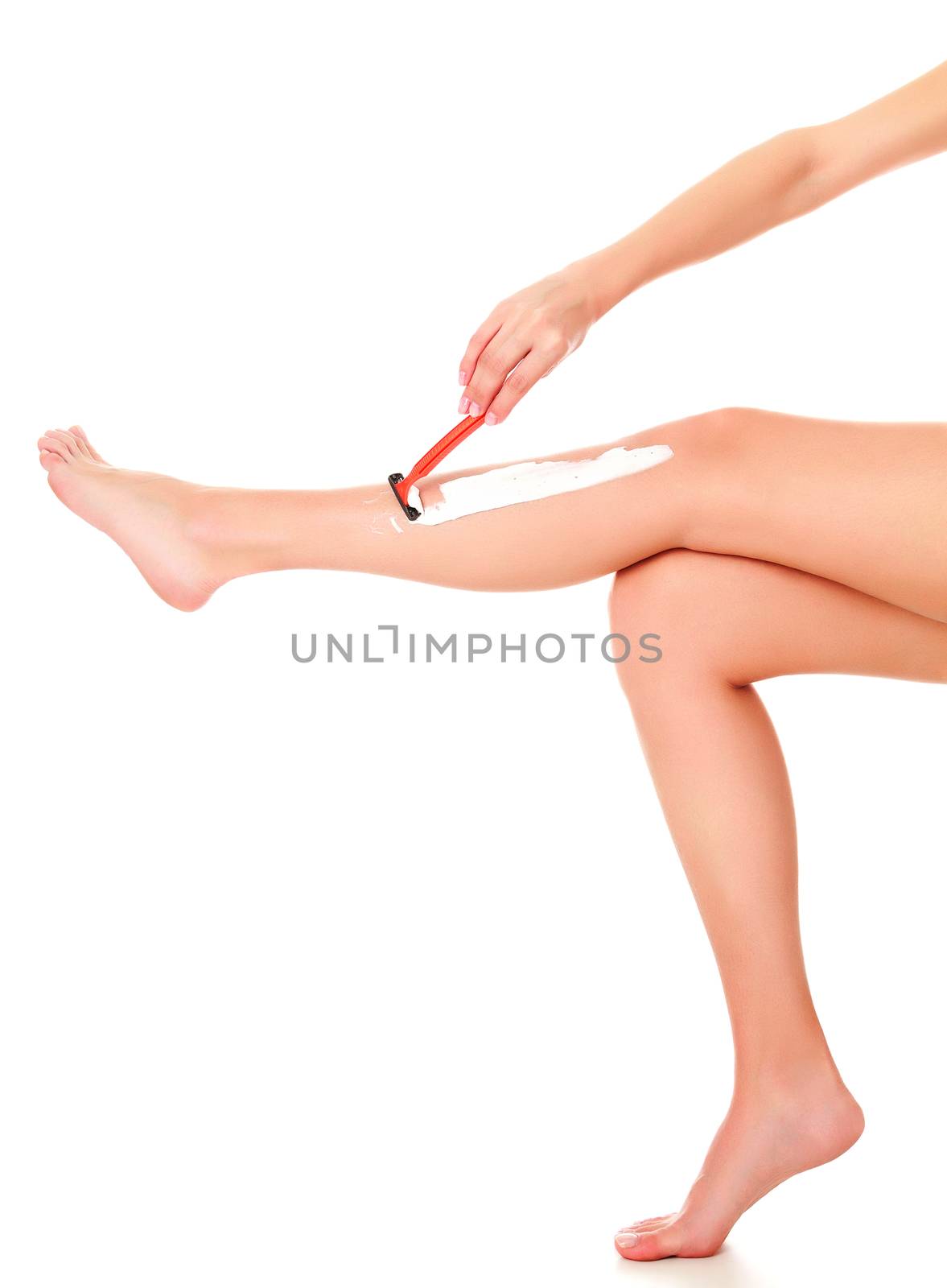 Woman shaves her leg, isolated on white background