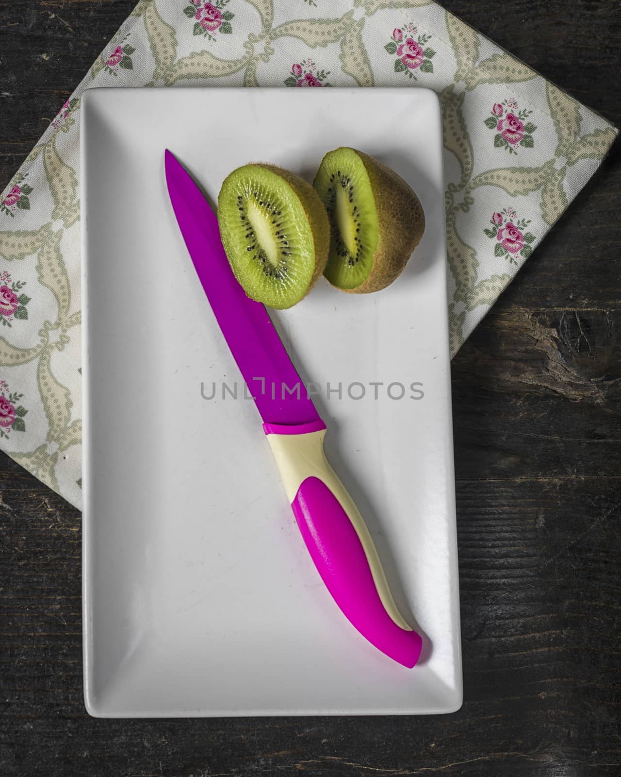 Kiwi Fruit and fuchsia knife, close up by verbano