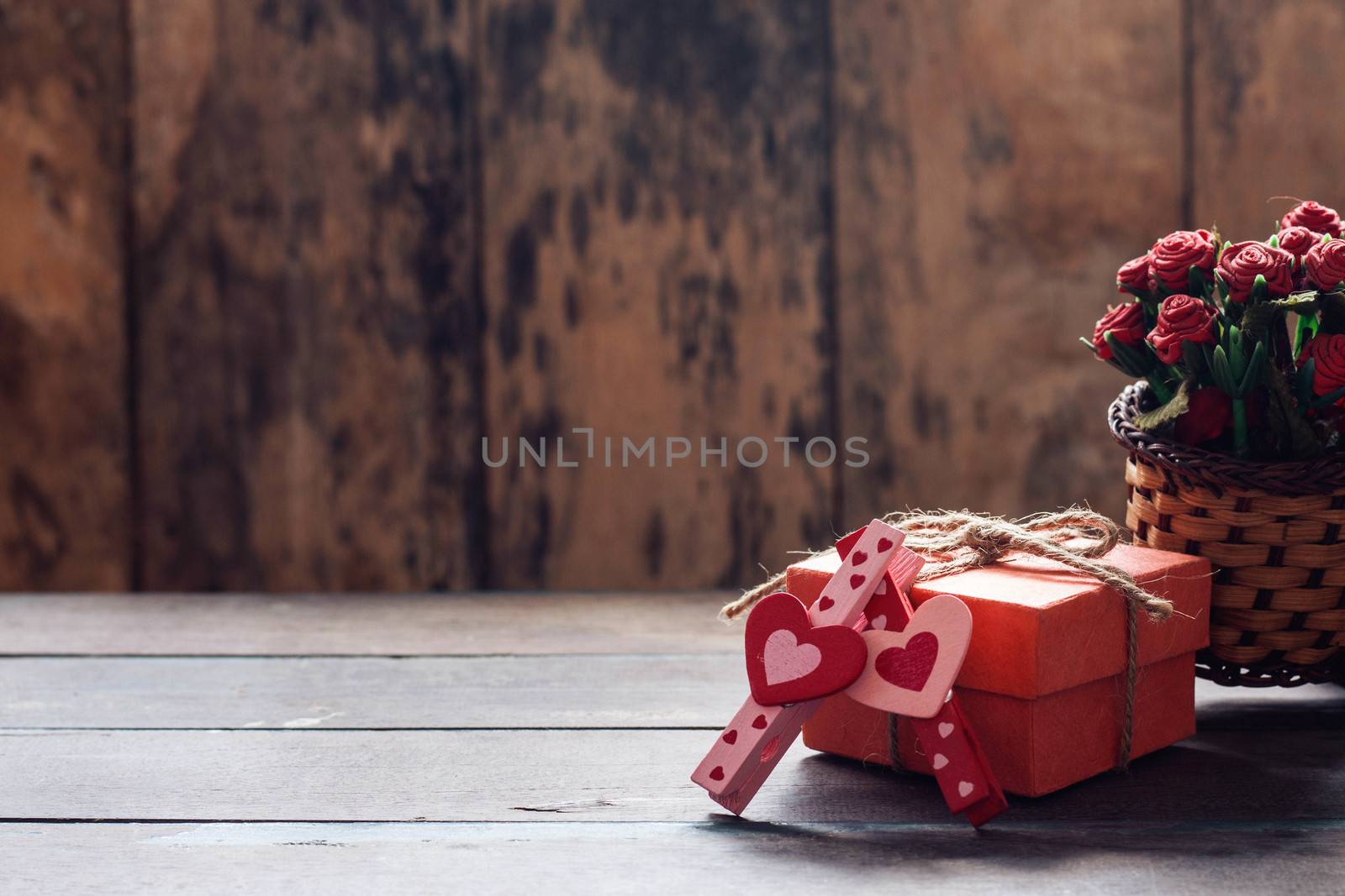 pink and red heart shaped and gift box on a wooden table.