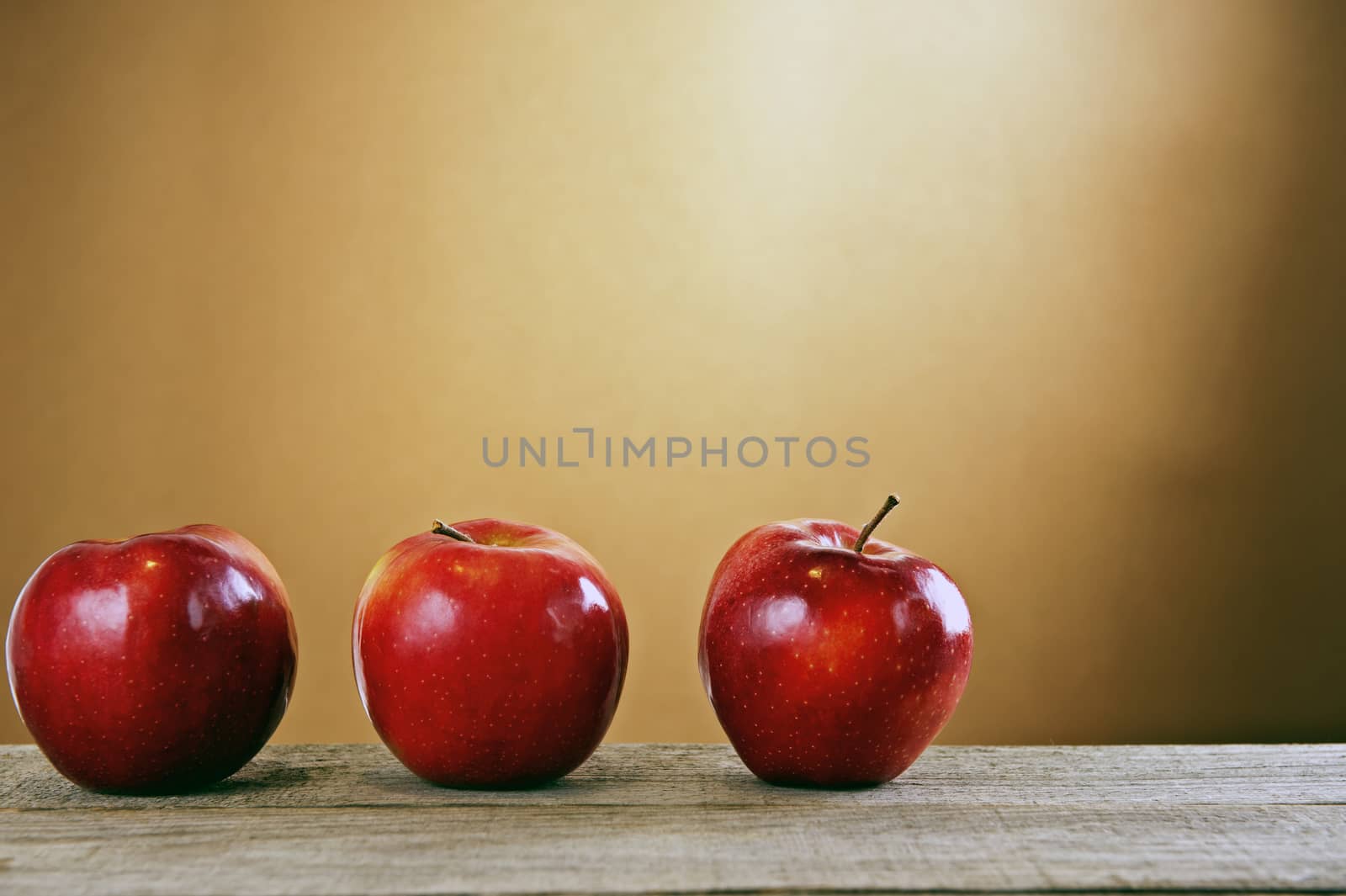 Red apples on a wooden table