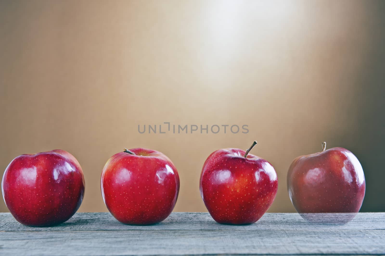 Red apples on a wooden table by Michalowski