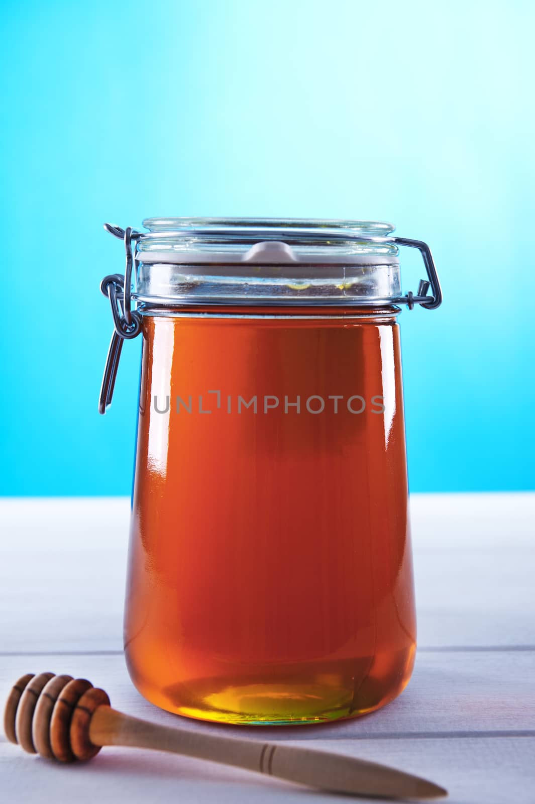 Polish jar of honey flower on a blue background