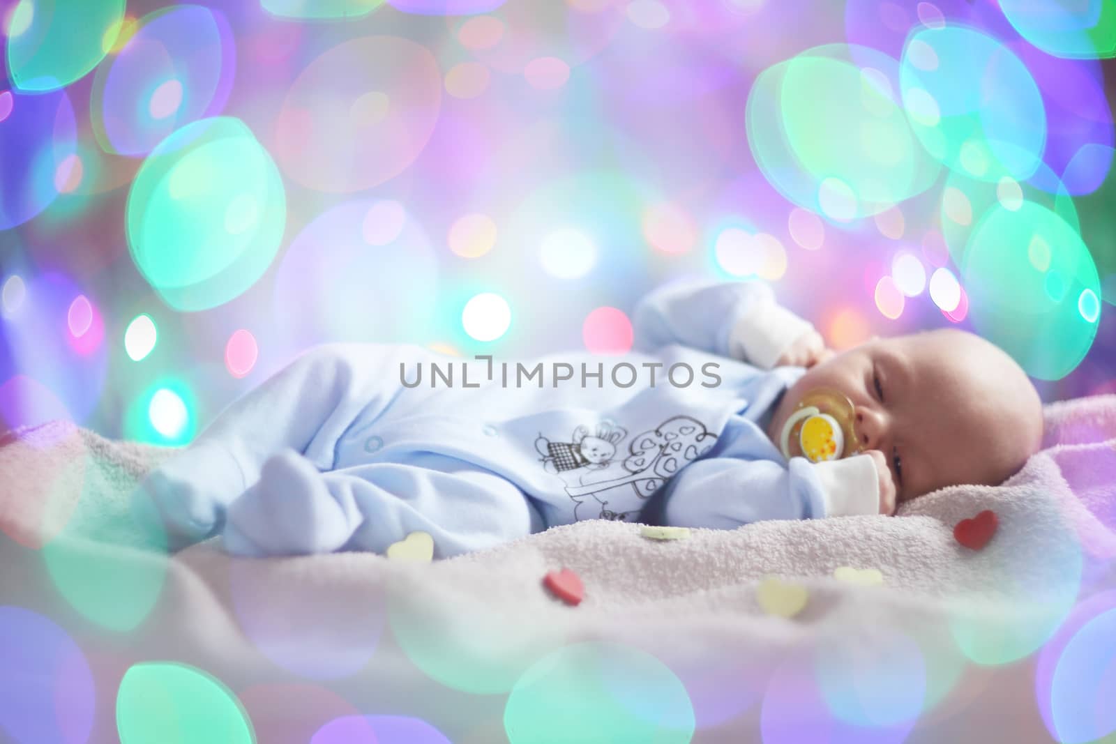 Love newborn baby Valentines day concept woth gearts and bokeh lights