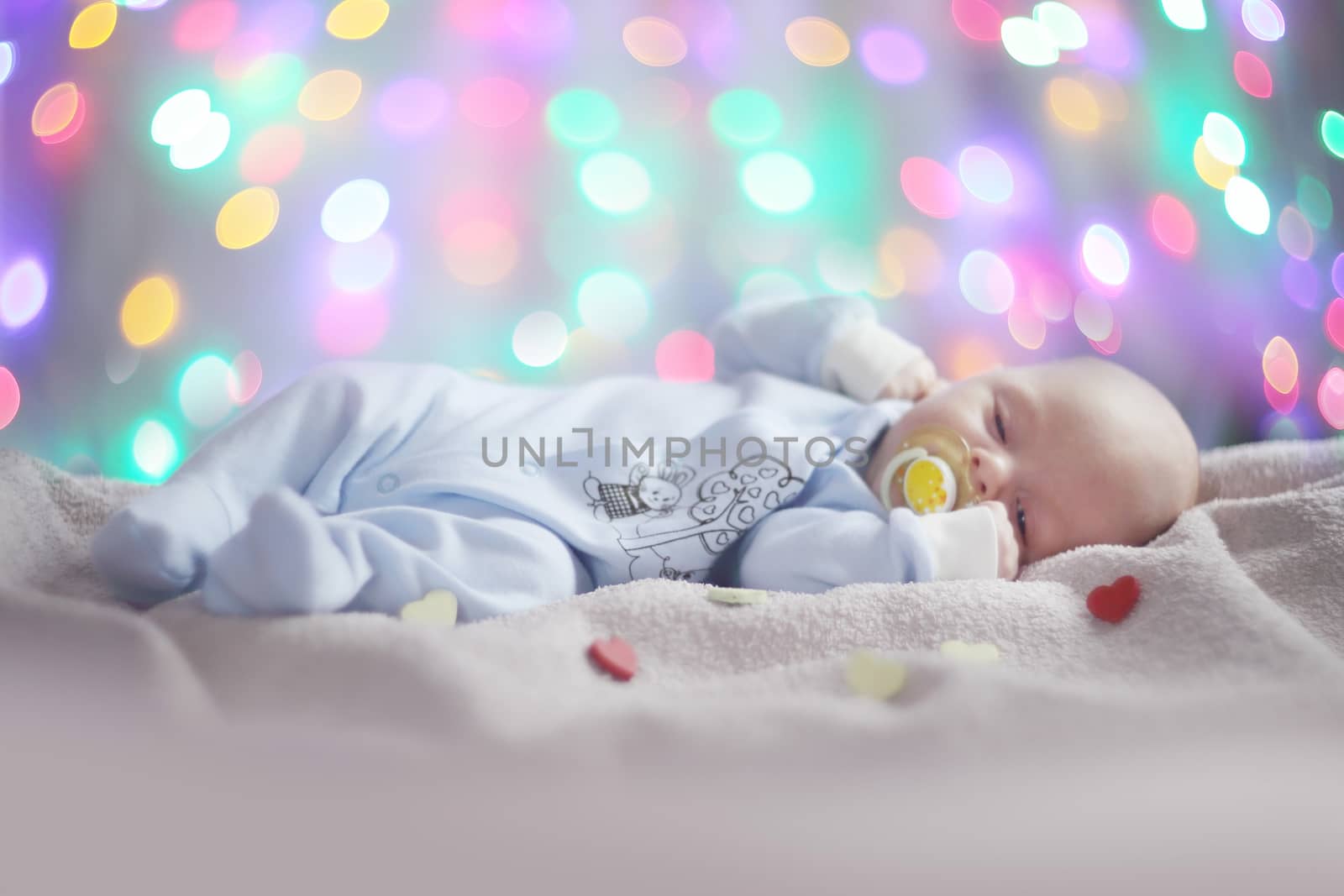 Love newborn baby Valentines day concept woth gearts and bokeh lights