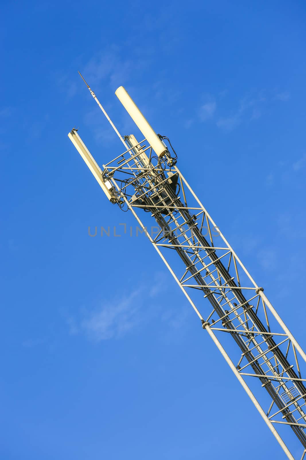 A high telecommunication network antenna and the beautiful clear blue sky