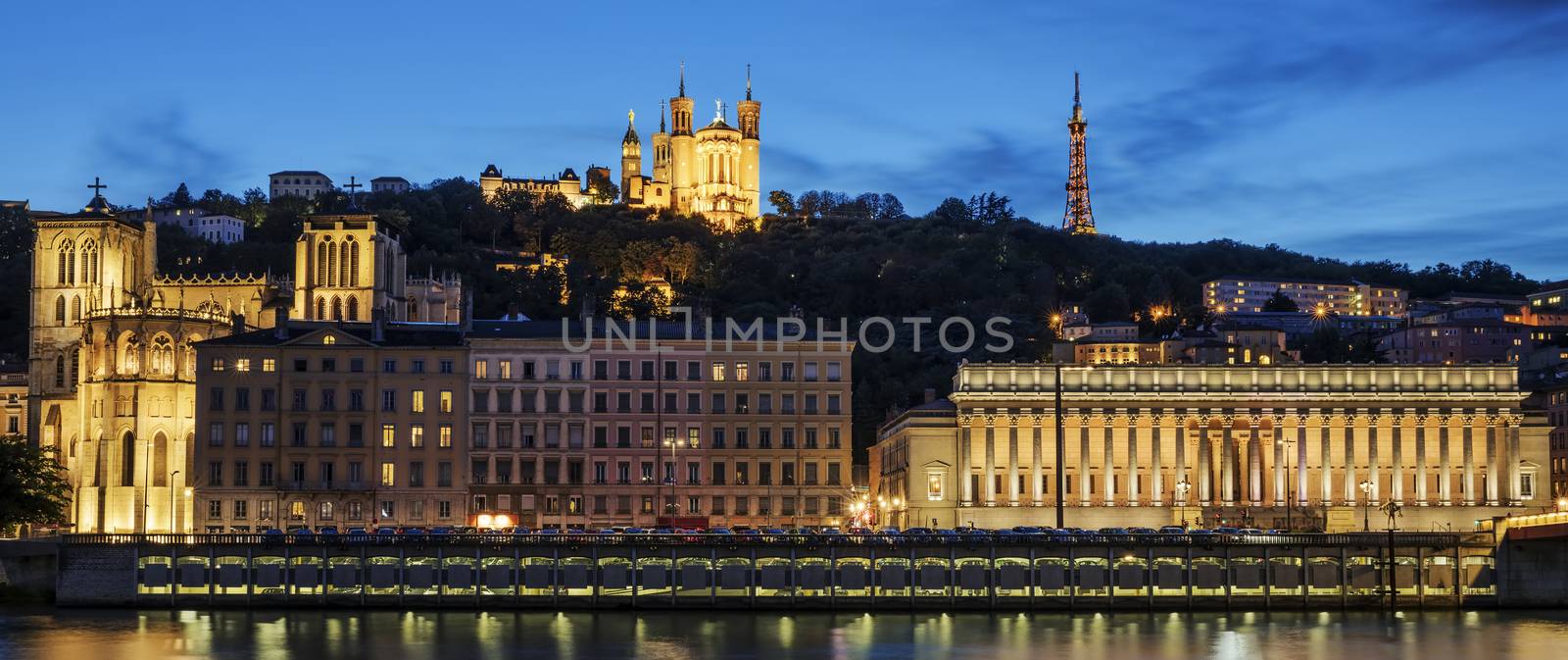 Night view over the Saone river to the Fourviere cathedral in Lyon city.
