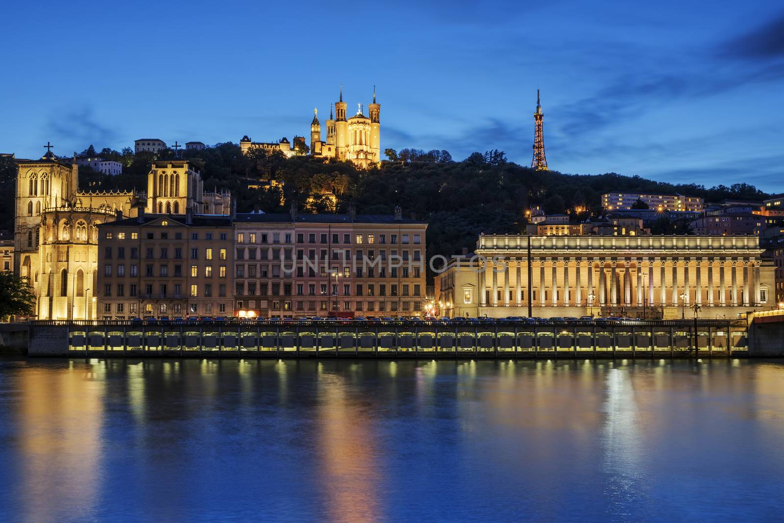 Night view over the Saone river to the Fourviere cathedral in Lyon city.