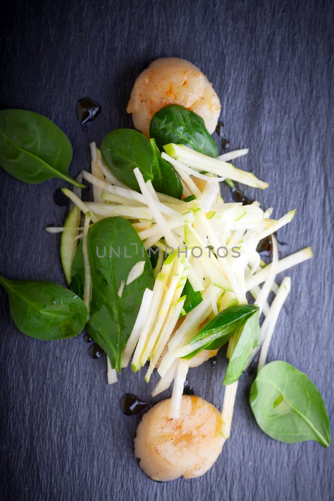 Scallop salad with apple, spinach on a stone plate. by supercat67