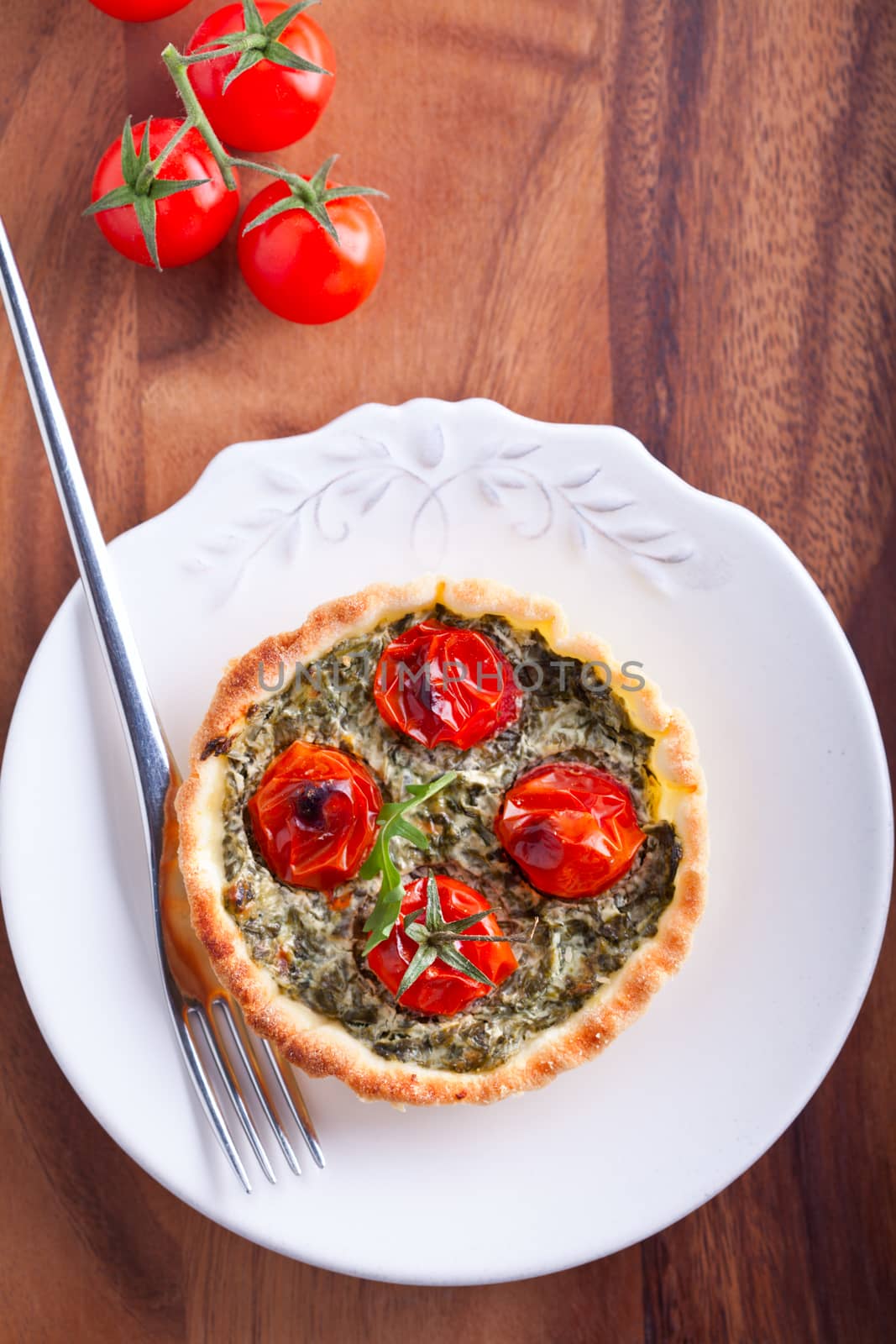 Mini Spinach Quiche with tomato served on a plate