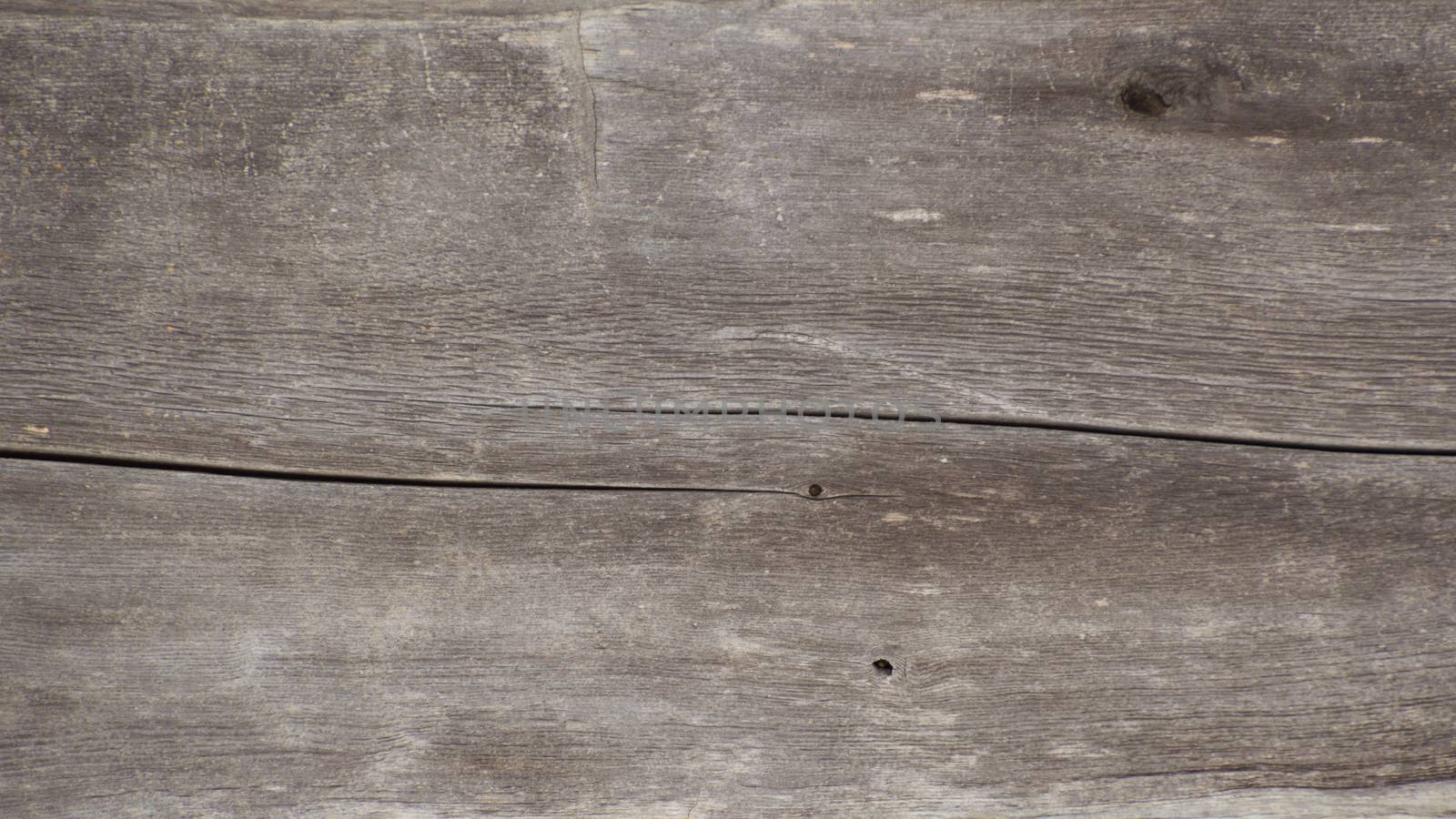 Old log cabin wood timber closeup with wood grain and adze marks. Background