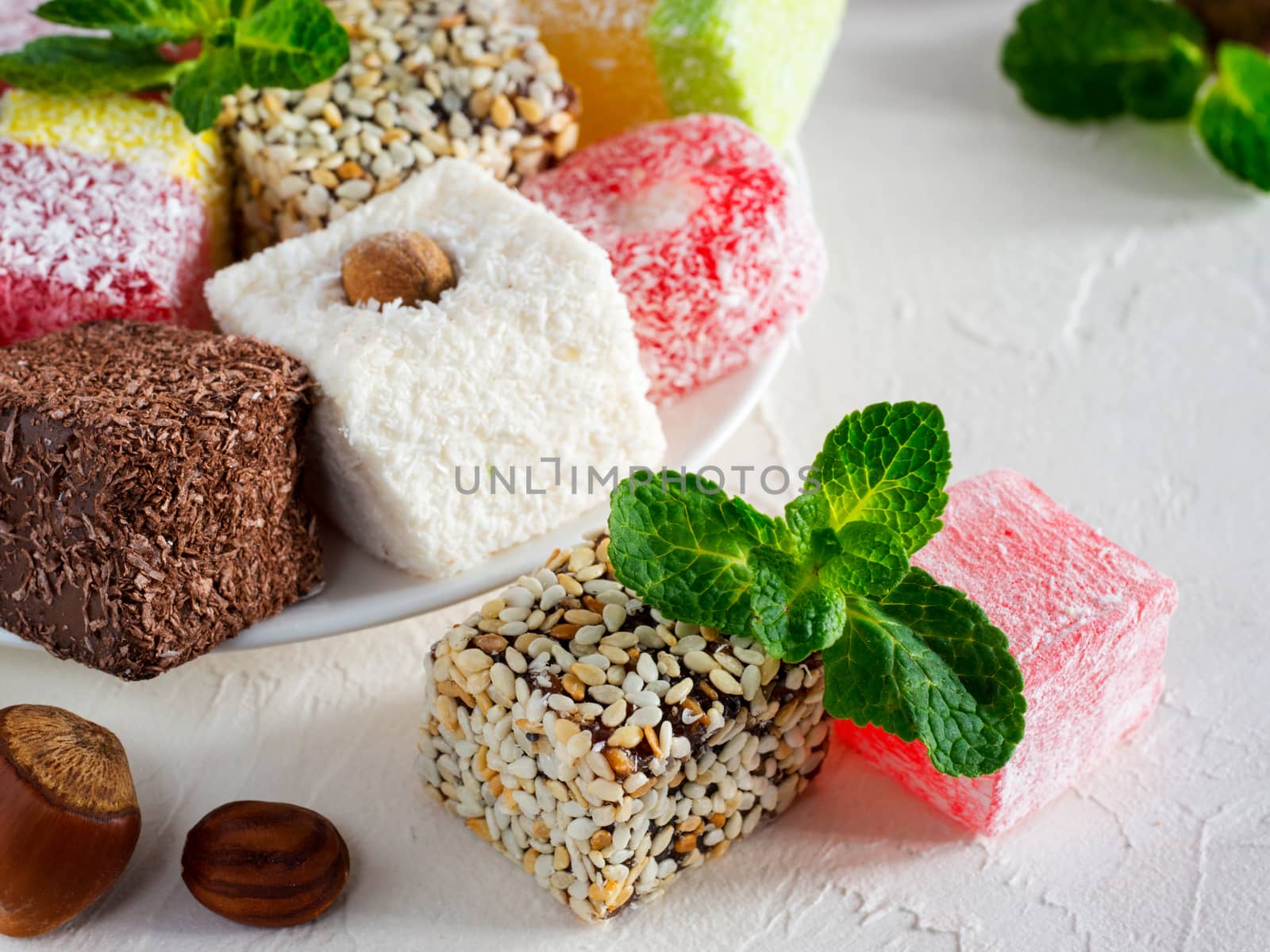 Turkish delight on white rustic background. Turkish deligh set. Assorted traditional turkish delight on oriental background