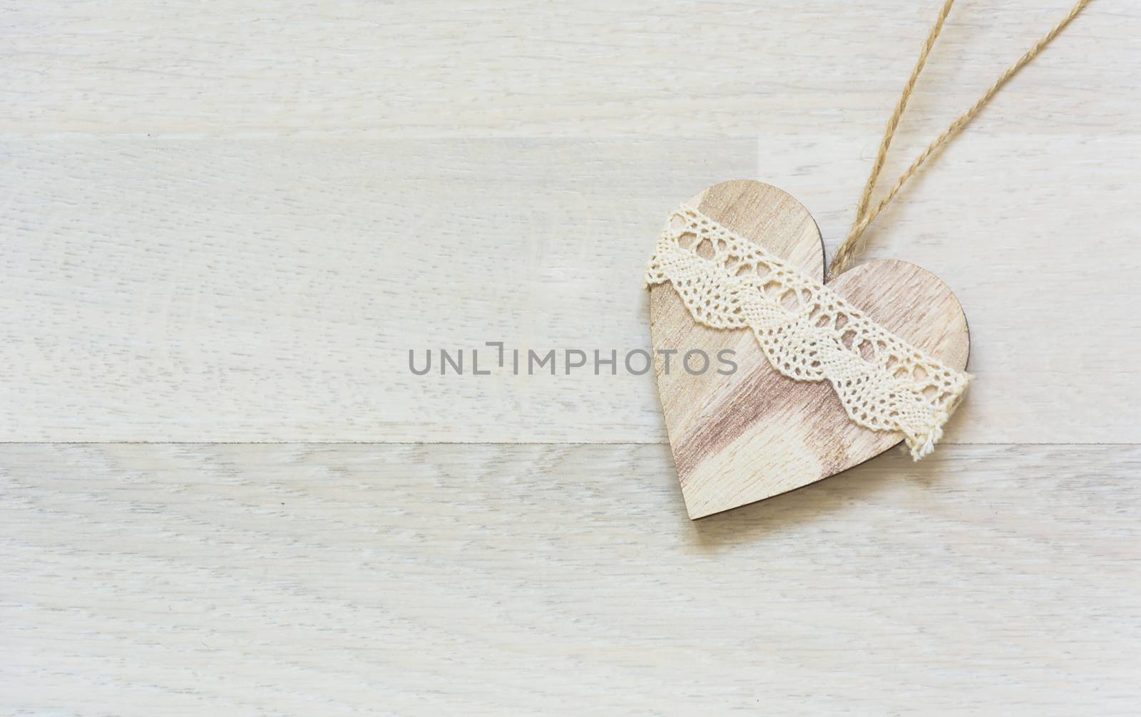 white wooden heart placed nicely on a wood background