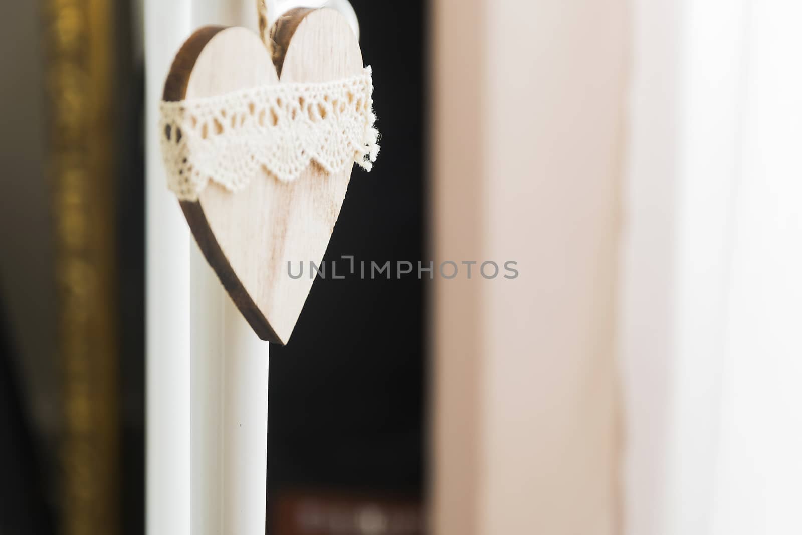 decorated wooden heart hanging in natural light