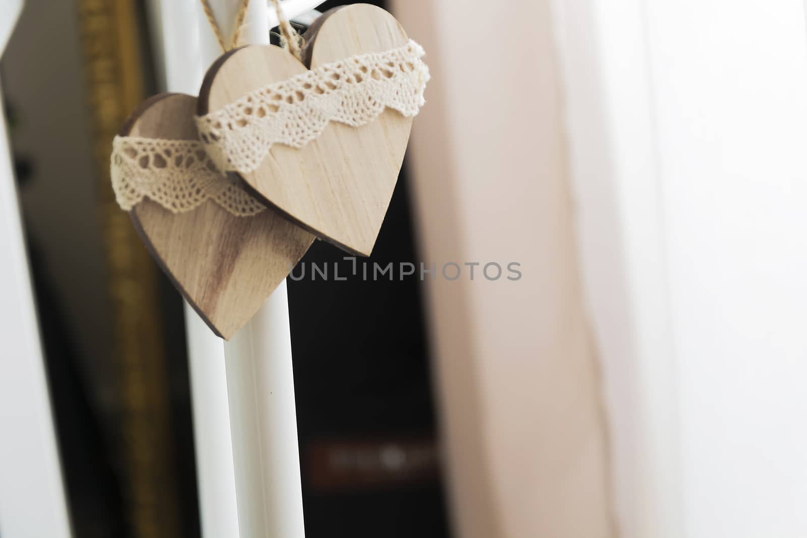 two wooden hearts hanging in natural light