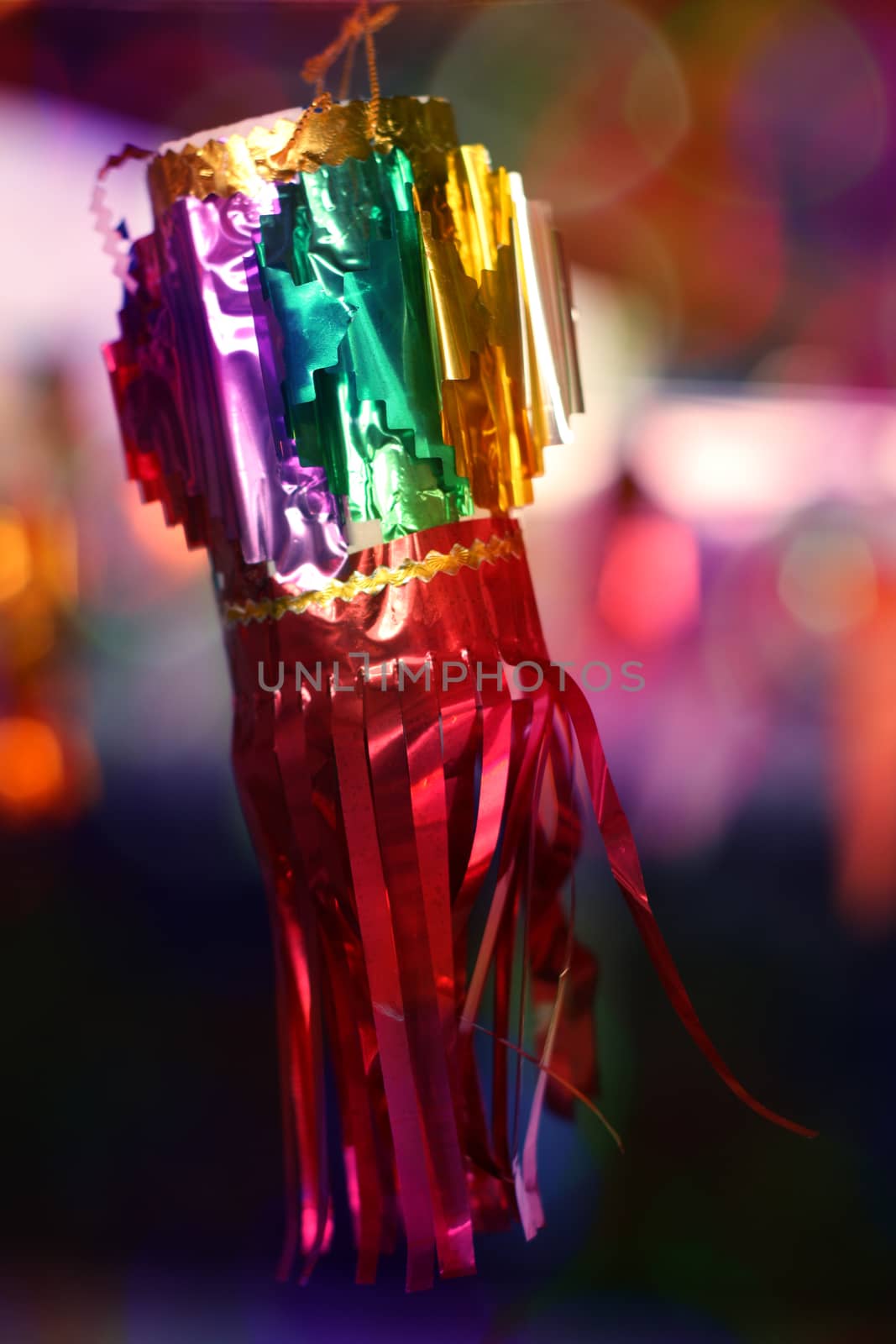 A traditional glittering Diwali festival lantern on the through colorful blur lights.