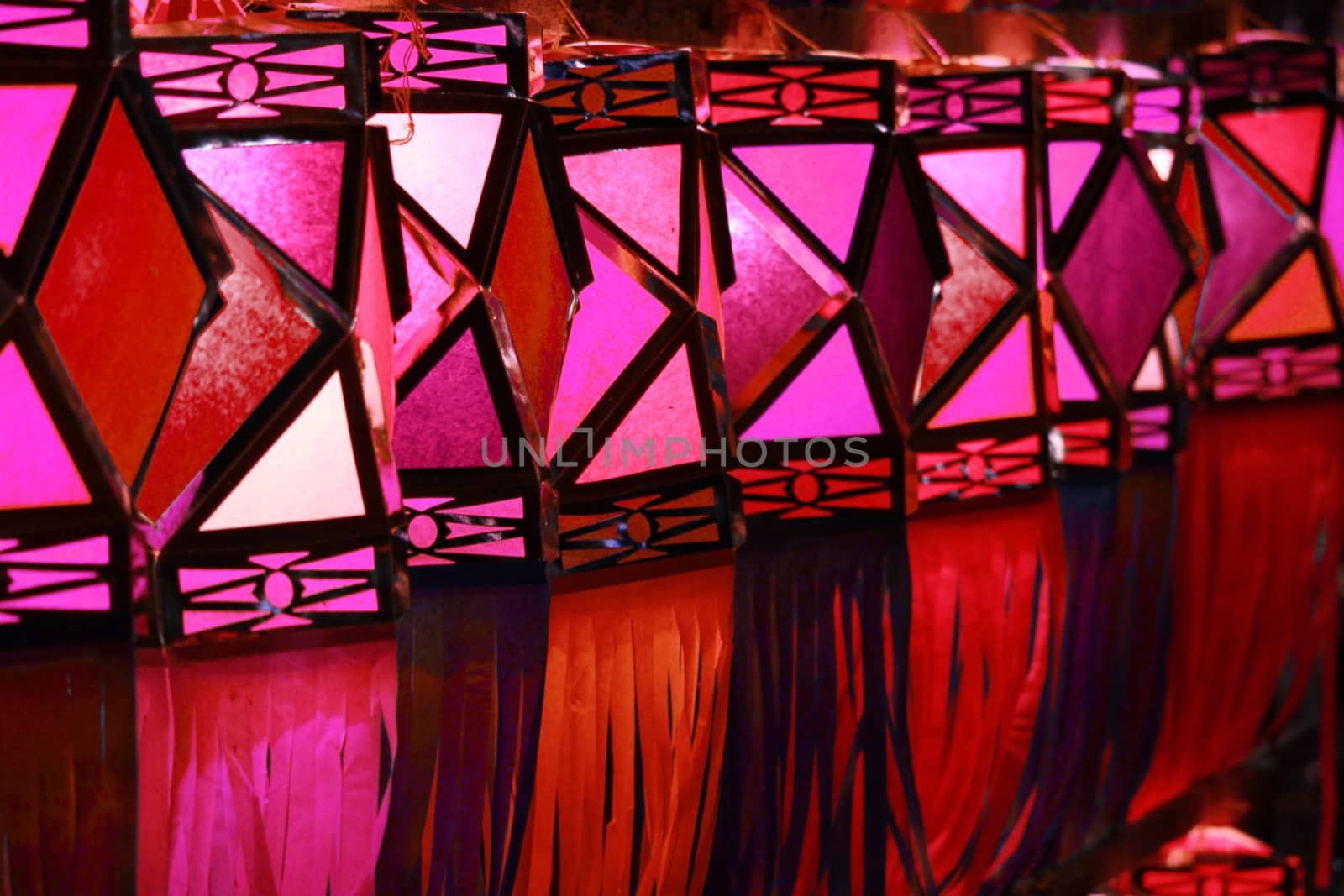 A line of traditional handmade Diwali lanters in red color used for decoration in the hindu festival in India.