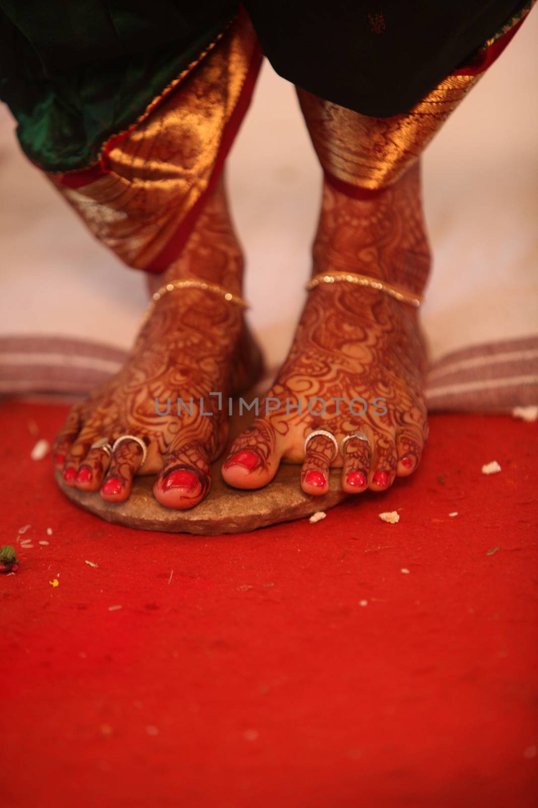 The feet of an Indian bride during the ritual in a traditional Hindu wedding.