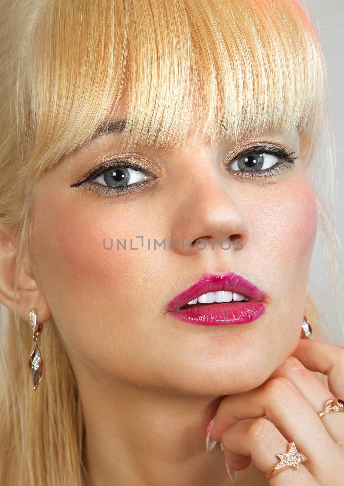 makeup on face of beautiful blonde woman, she looks on