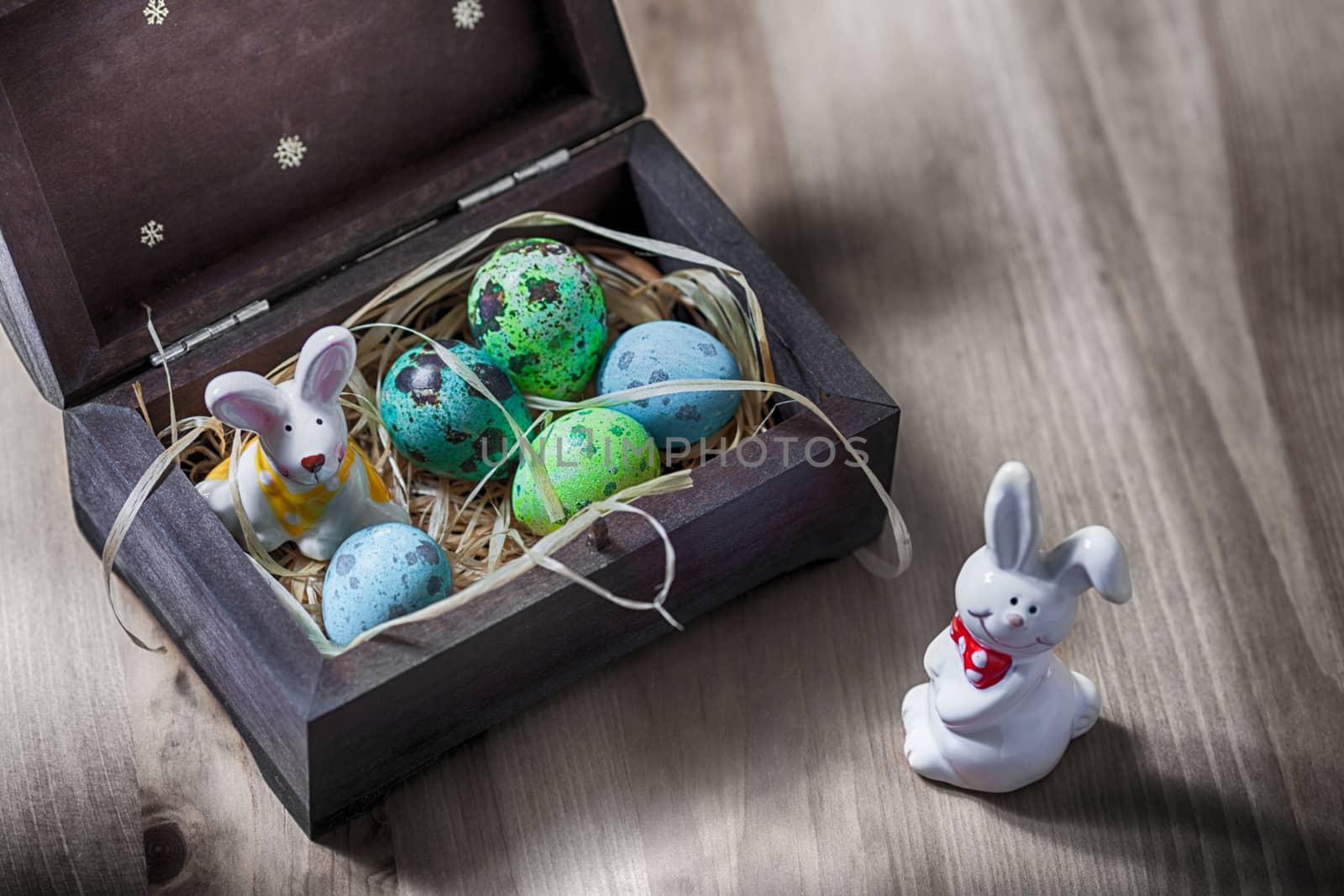 Easter bunny with colorful eggs in a box 
