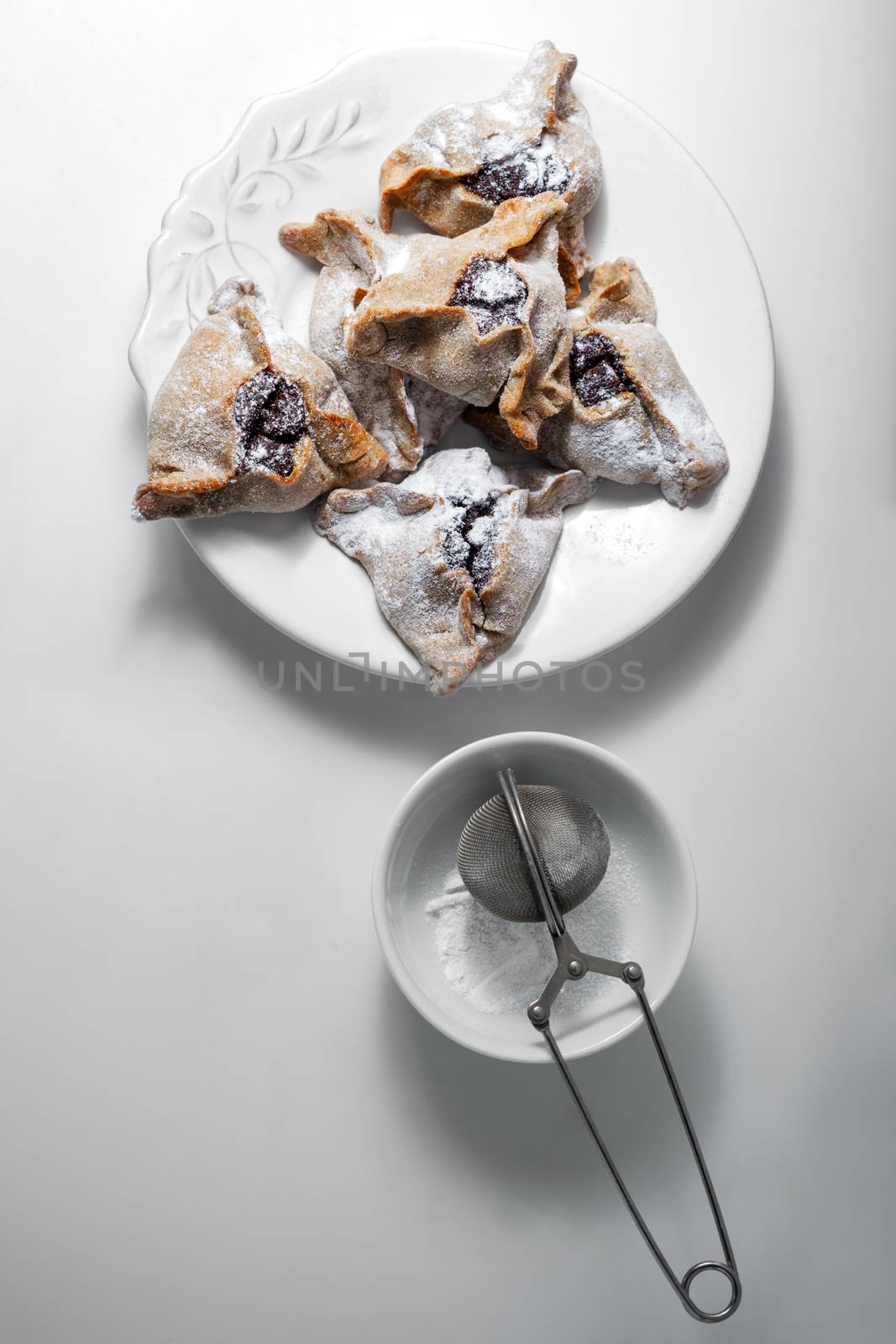 Hamantaschen Cookies for Purim on a white plate. by supercat67