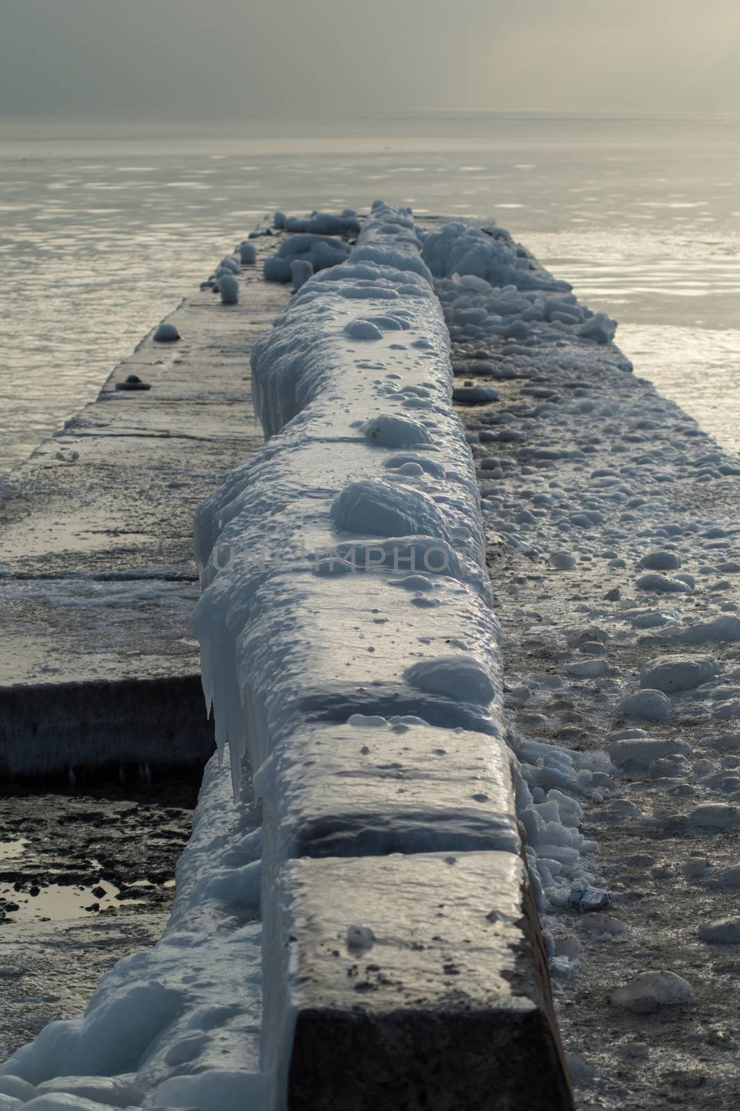 Ice-covered Pier Early in a Morning by Multipedia