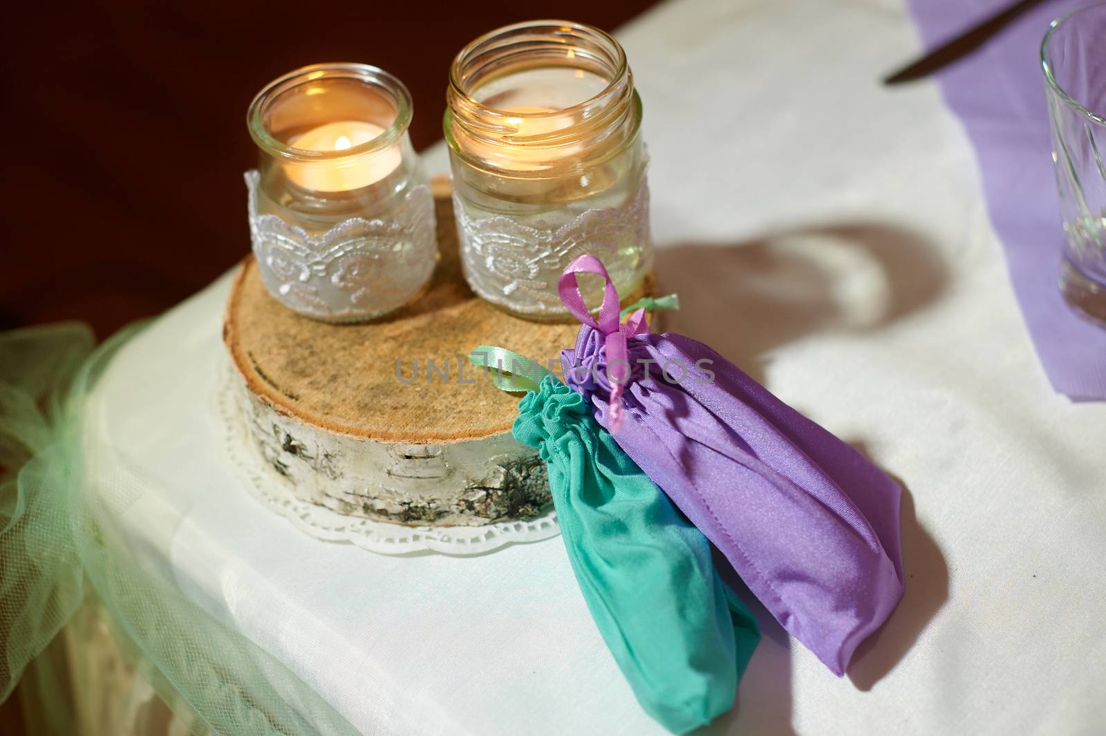 Wedding decoration of the candles on the table in a rustic style.