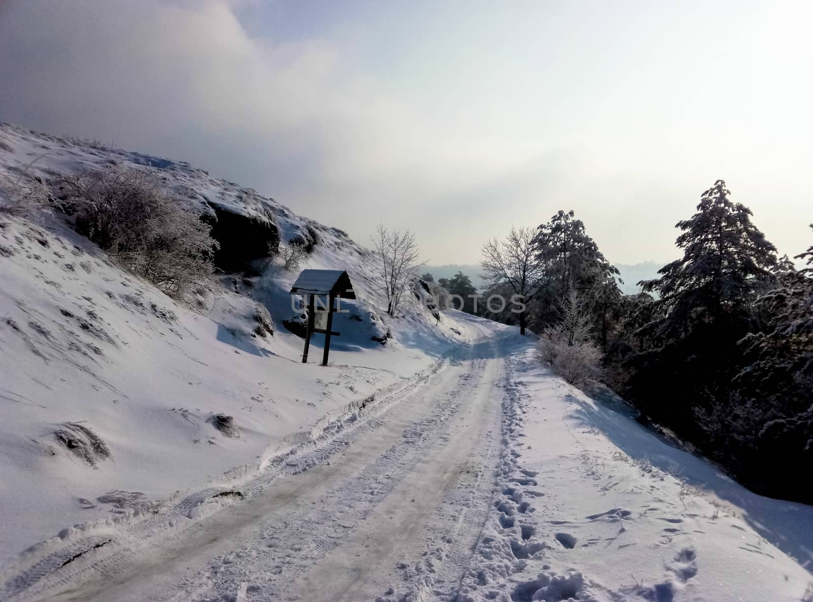 snowy road in the mountains on the edge of the sky by Oleczka11