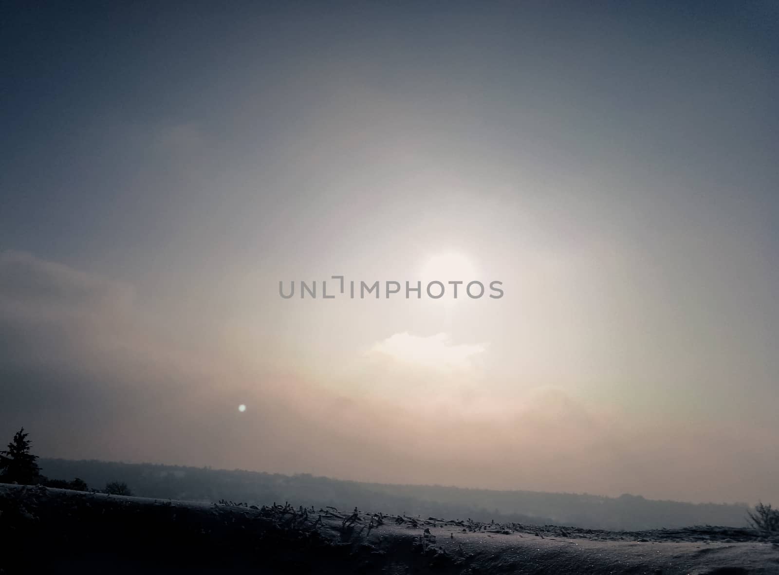 beautiful sunset on top of a hill in the winter