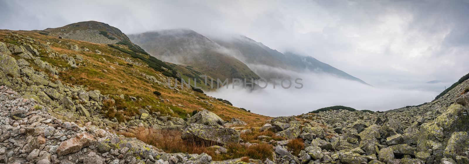 Mountains Landscape with Fog in Ziarska Valley. Rocks in Foreground.