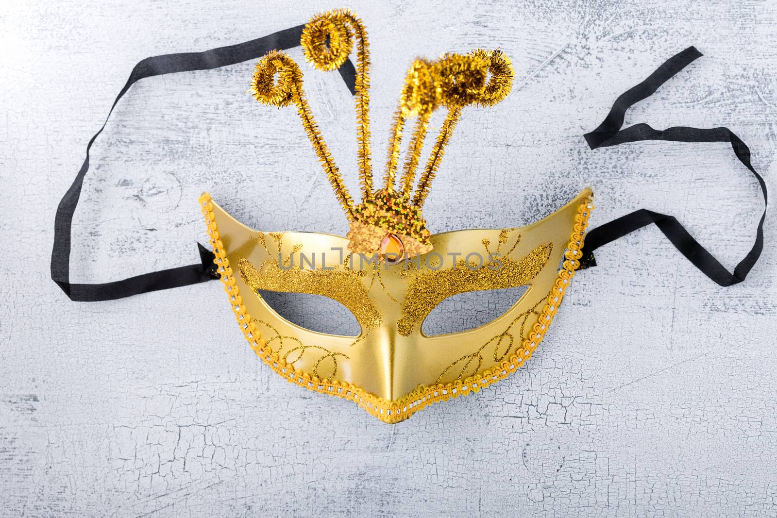 Gold carnival mask on a white background