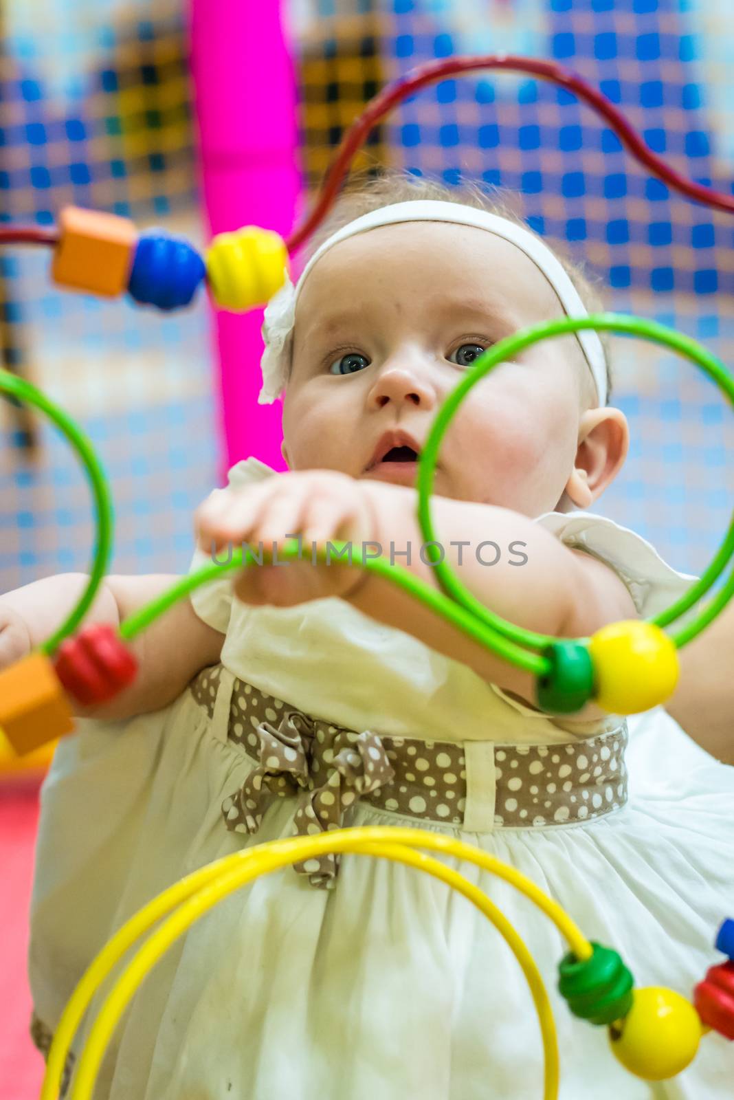 one of the babies playing in the nursery