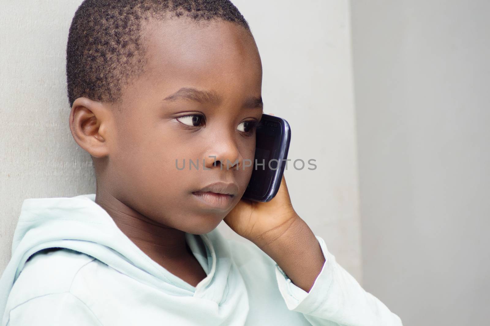Child listening with great attention that his mother told him on the phone.