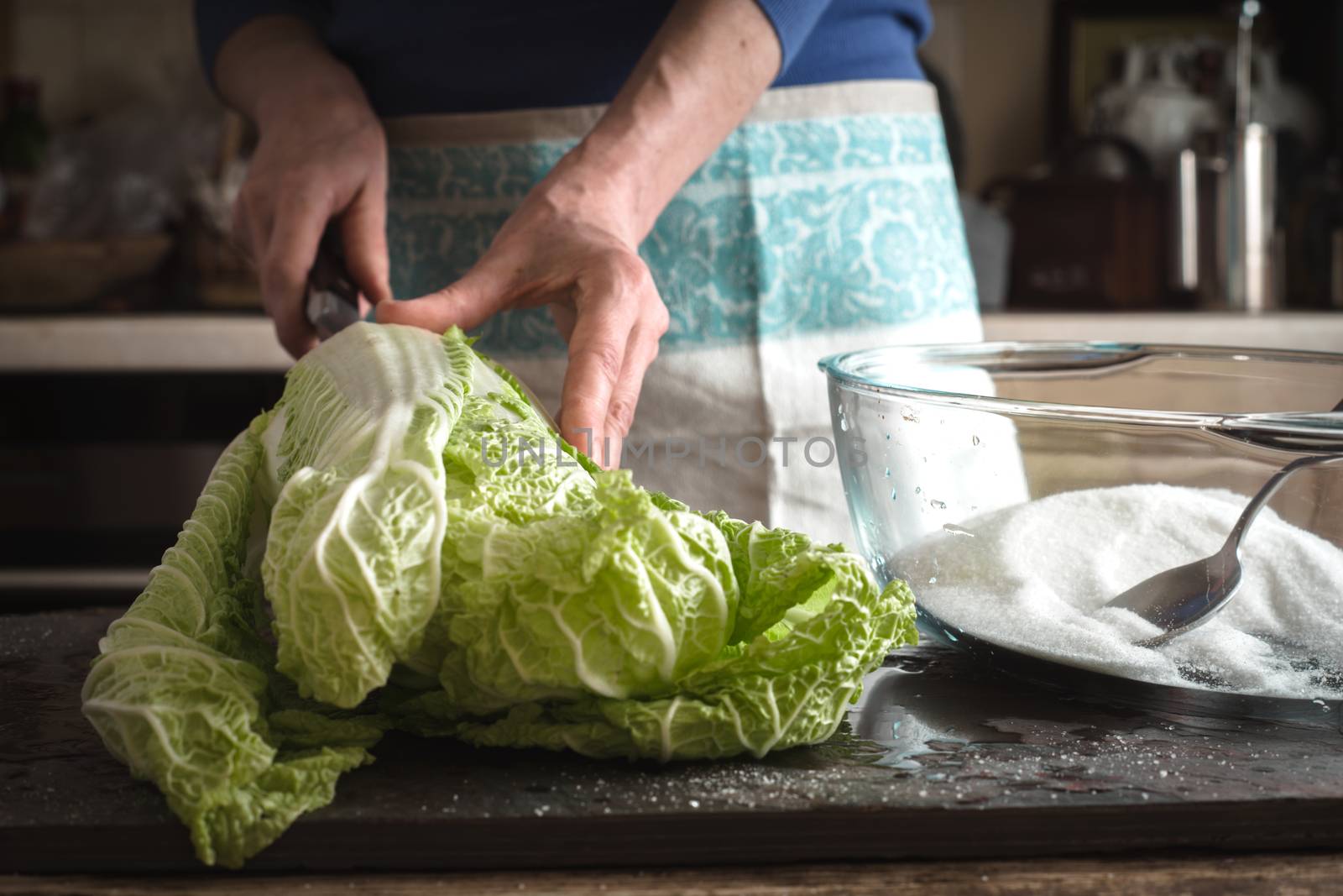 Woman cut Chinese cabbage to cook kimchi by Deniskarpenkov