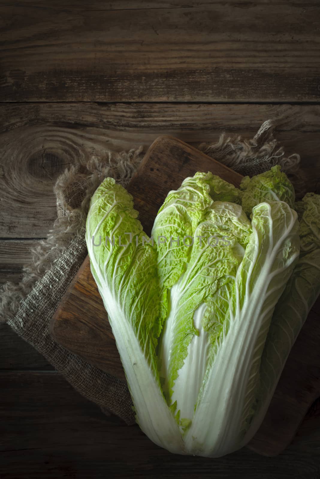 Chinese cabbage on a cutting board on a napkin vertical