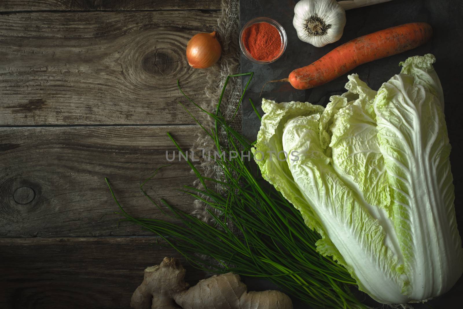 Chinese cabbage, carrot, chili for kimchi on old boards by Deniskarpenkov