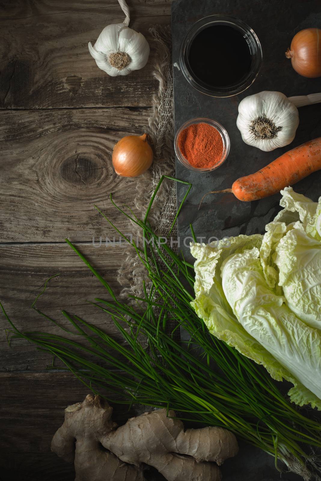 Chinese cabbage, vegetables and soy sauce kimchi on old boards by Deniskarpenkov