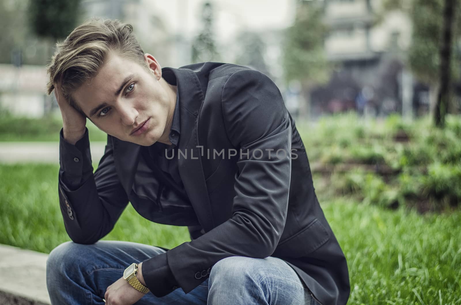 Depressed Young White Man Sitting at Street Side by artofphoto