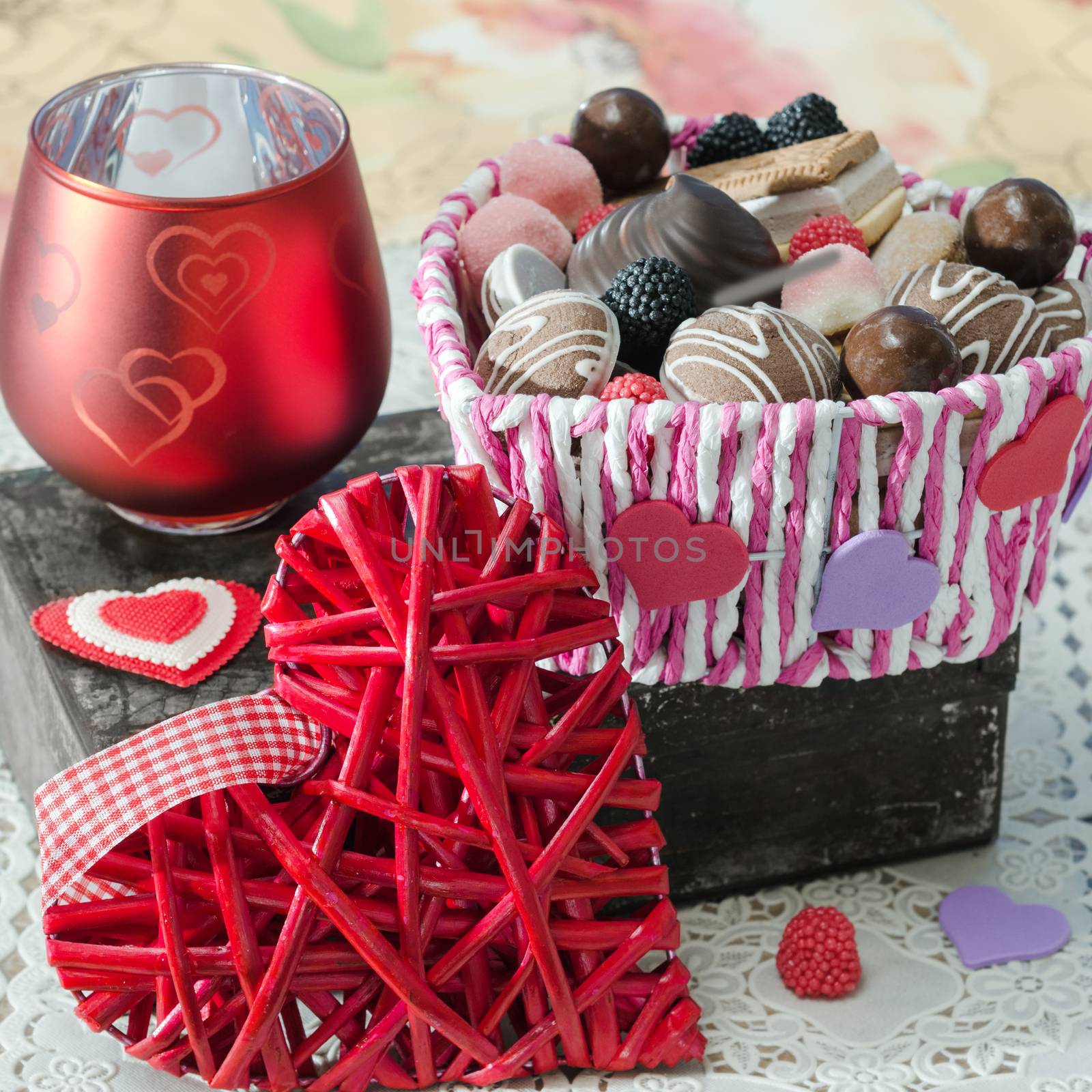 Basket of different candies, cookies and decorative Valentines day heart on the old box by Gaina