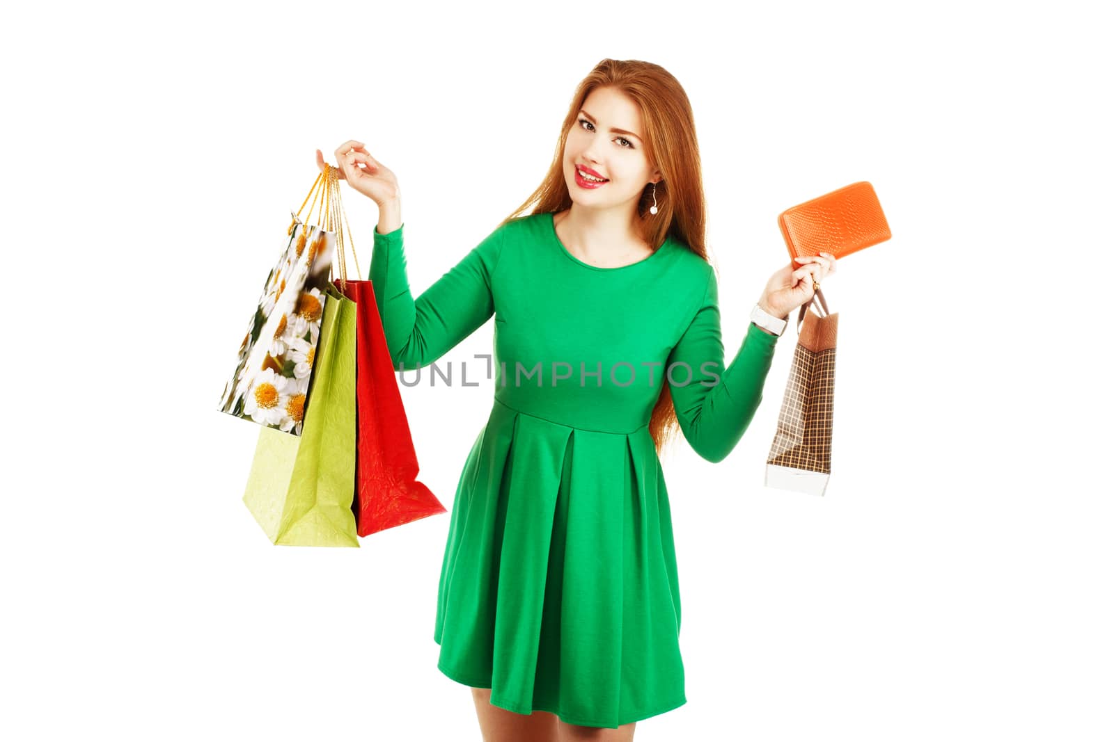 Beautiful happy girl posing with shopping bags isolated on a white background