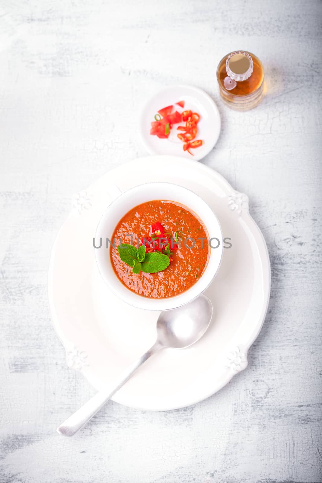 Bowl of Fresh tomato soup Gazpacho served on a table