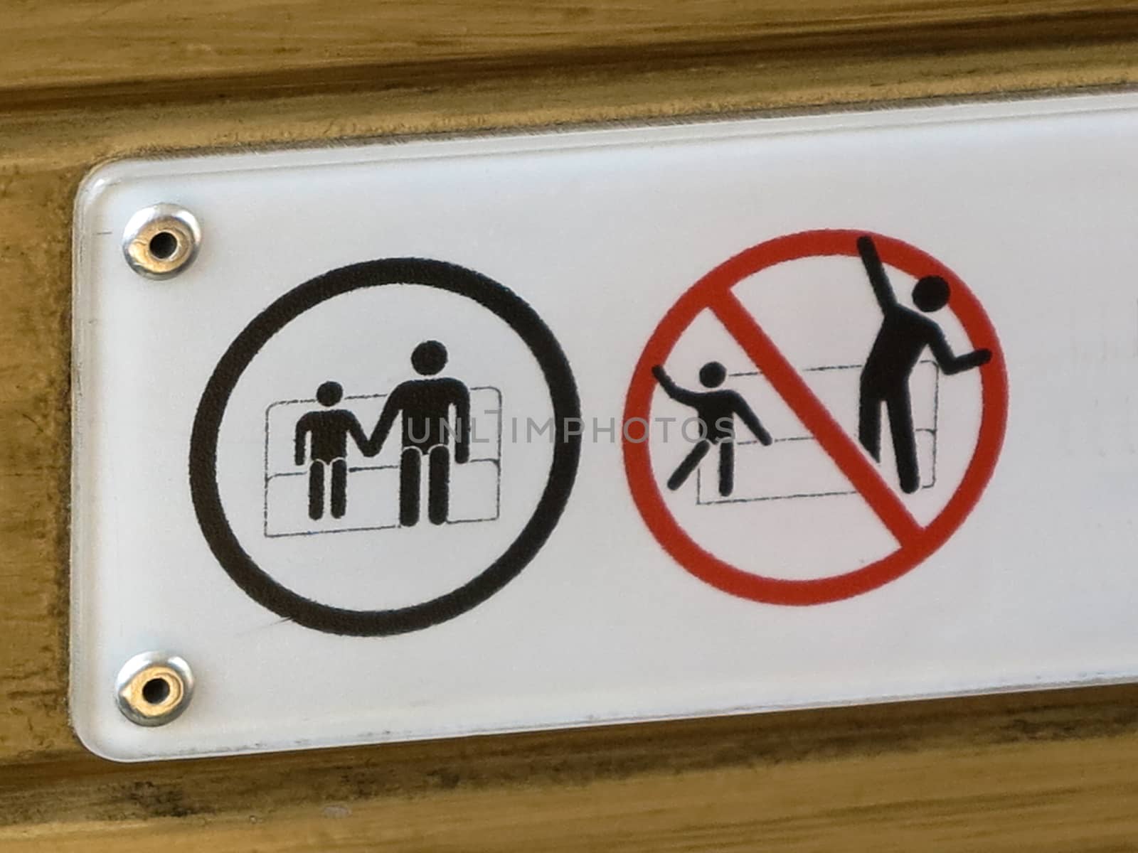 A safety sign asking passengers to sit down