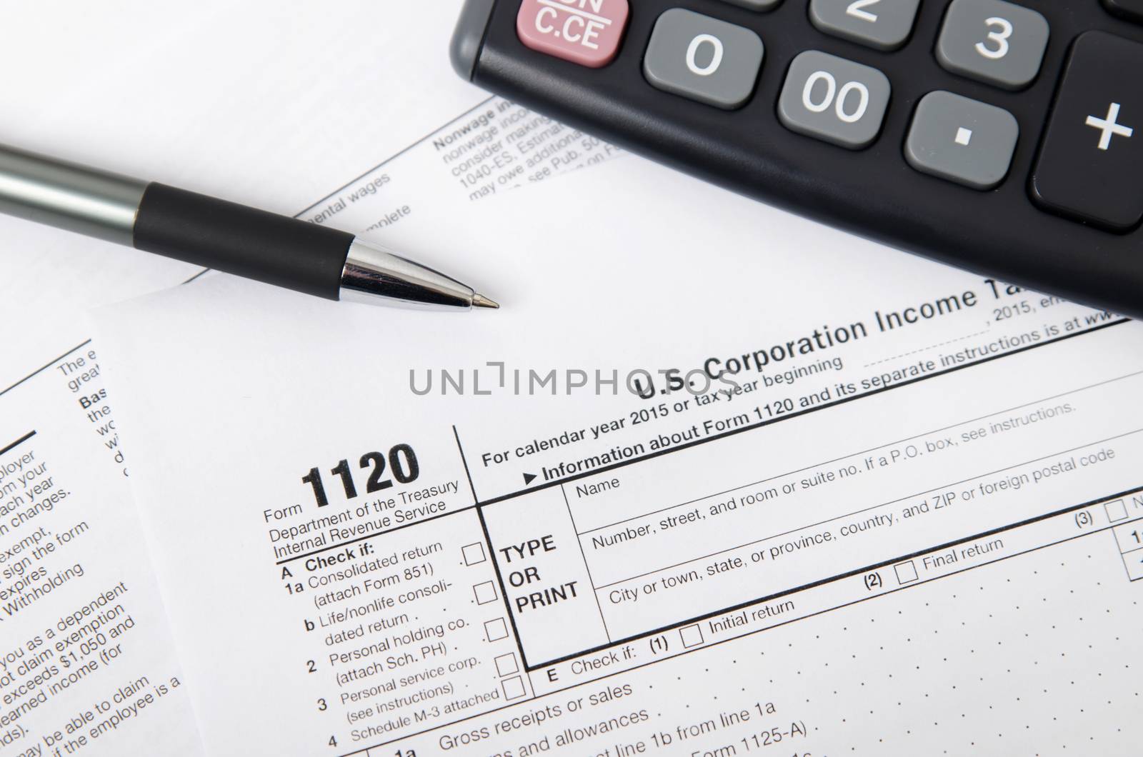 US tax form 1120 with pen and calculator by simpson33