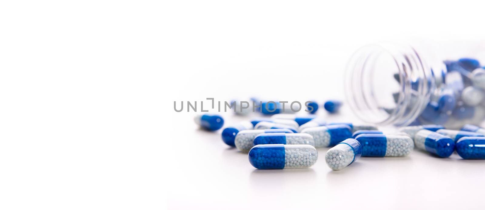 Pile of scattered capsules on a white background by simpson33