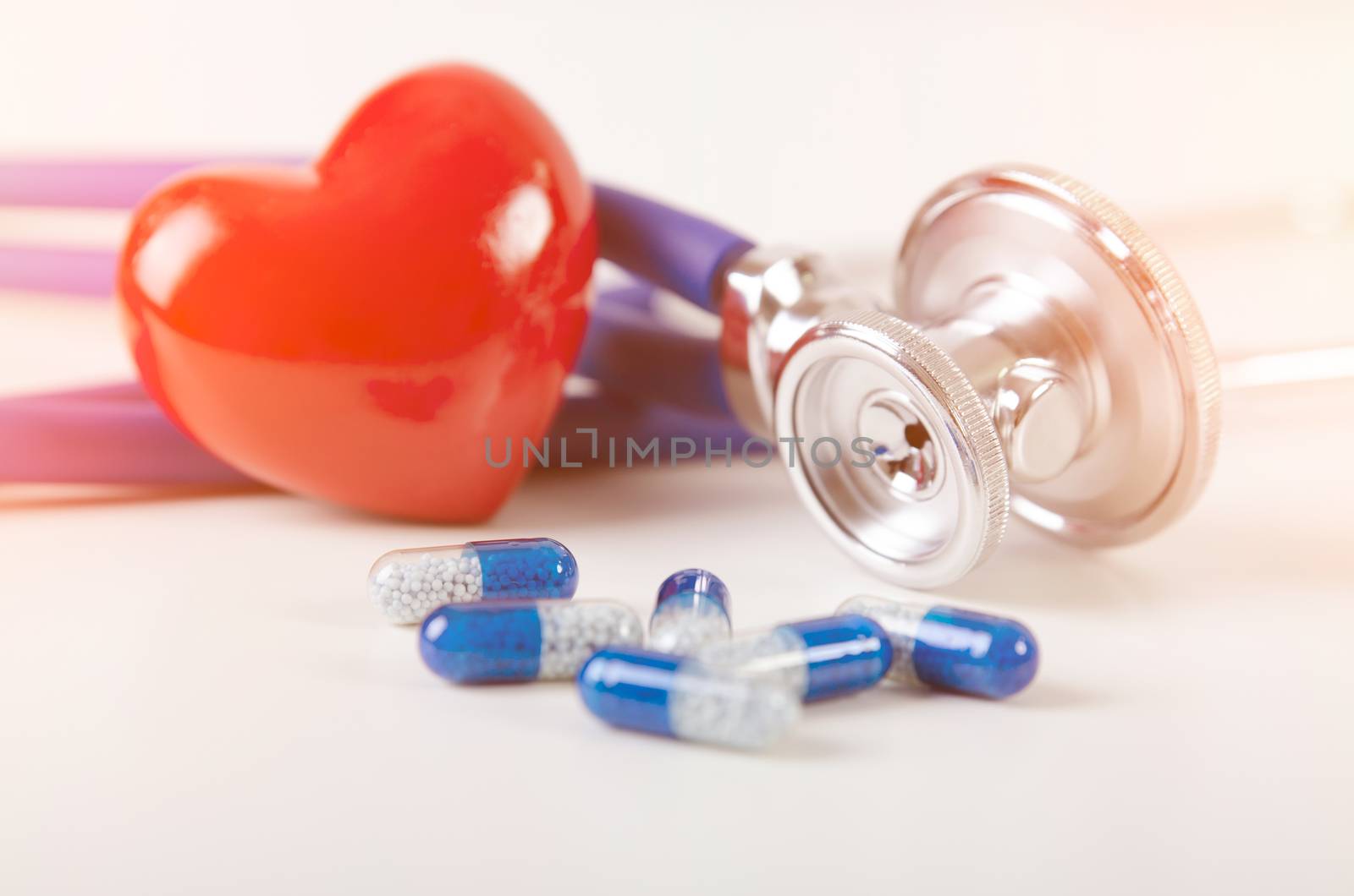 Health care with heart and stethoscope composition. medicine pill healthcare stethoscope drug medical capsule heart concept