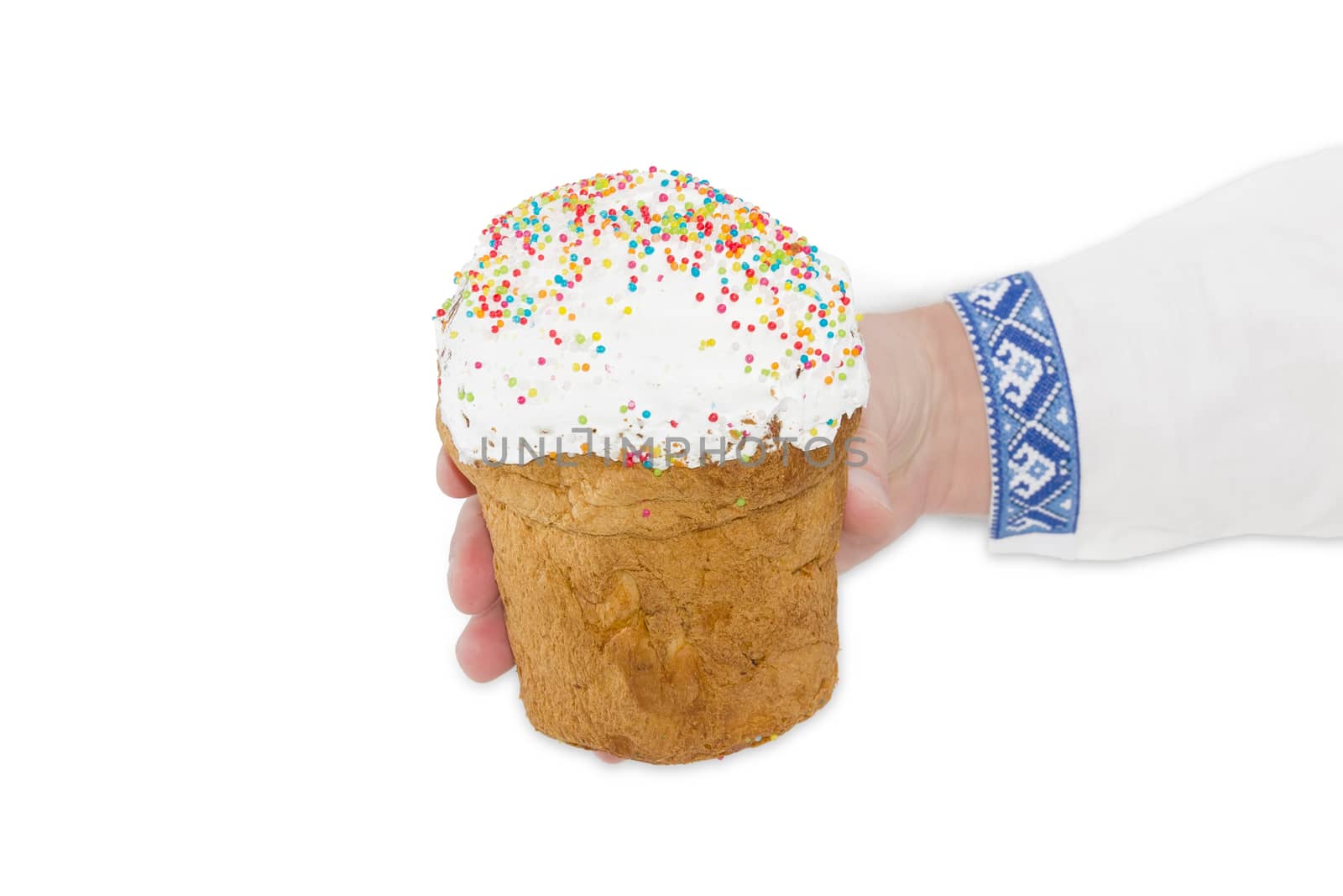 Easter cake decorated with white icing and colorful sugar decors in male hand on a light background
