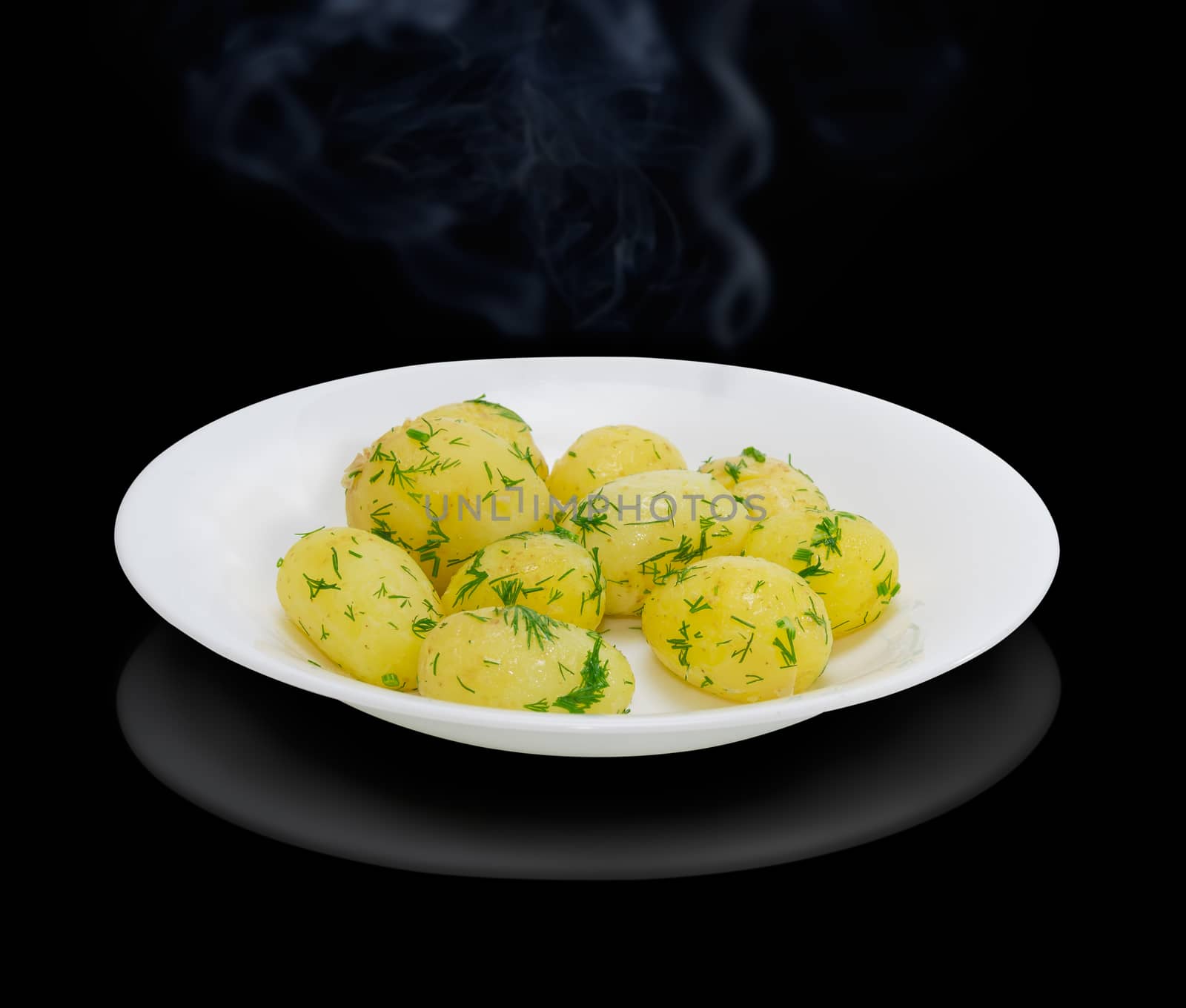 Boiled young potatoes with butter and dill on dark background by anmbph