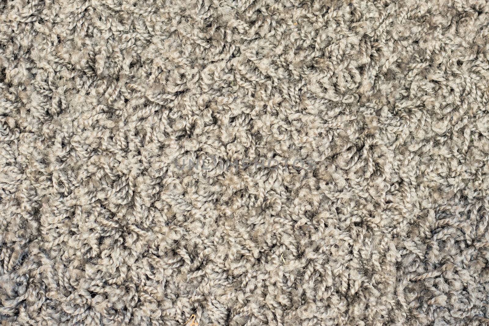 A full frame closeup in a gray and black carpet.
