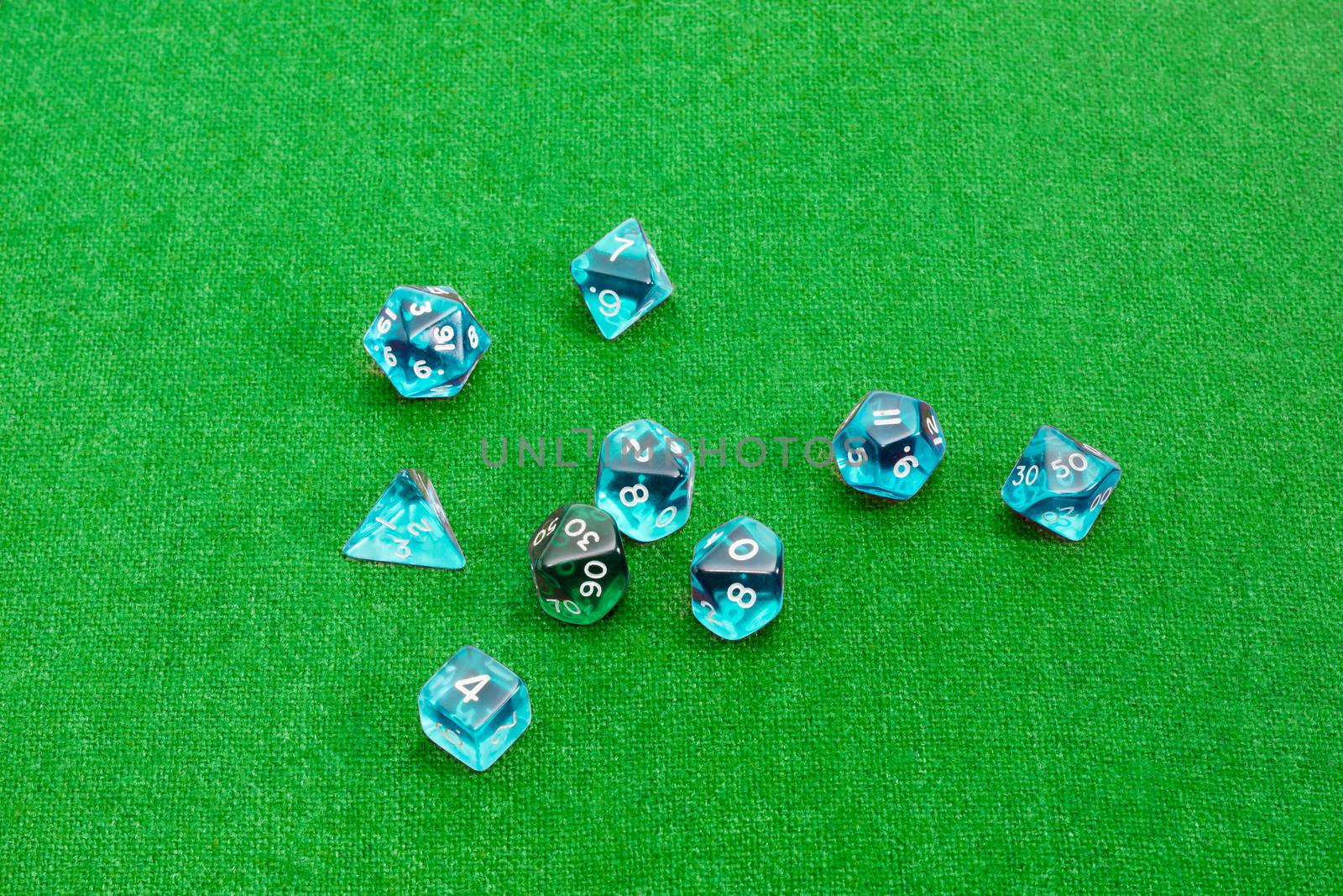 Specialized polyhedral dice for role-playing games on green clot by anmbph