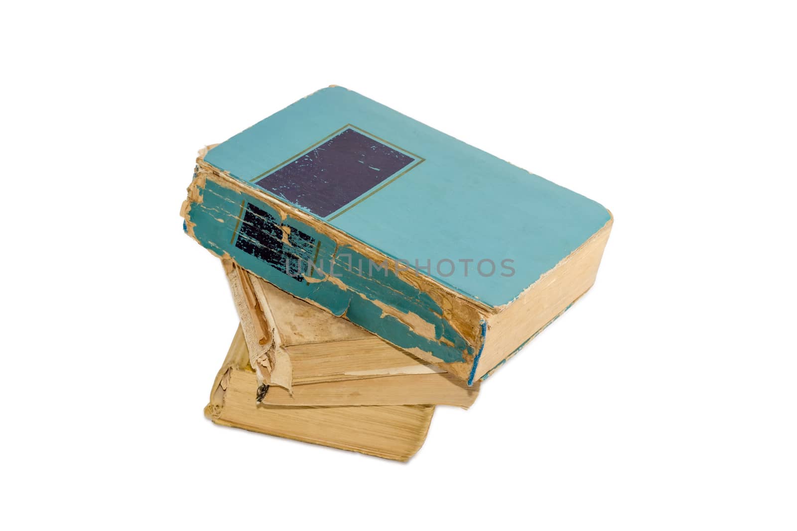 Stack of three old shabby books on a light background
